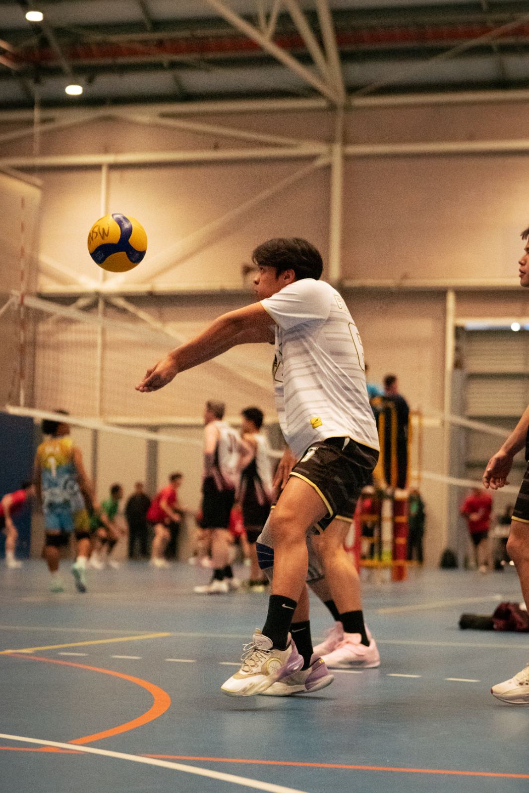 An adult player passing a serve in a Bossley Bears class