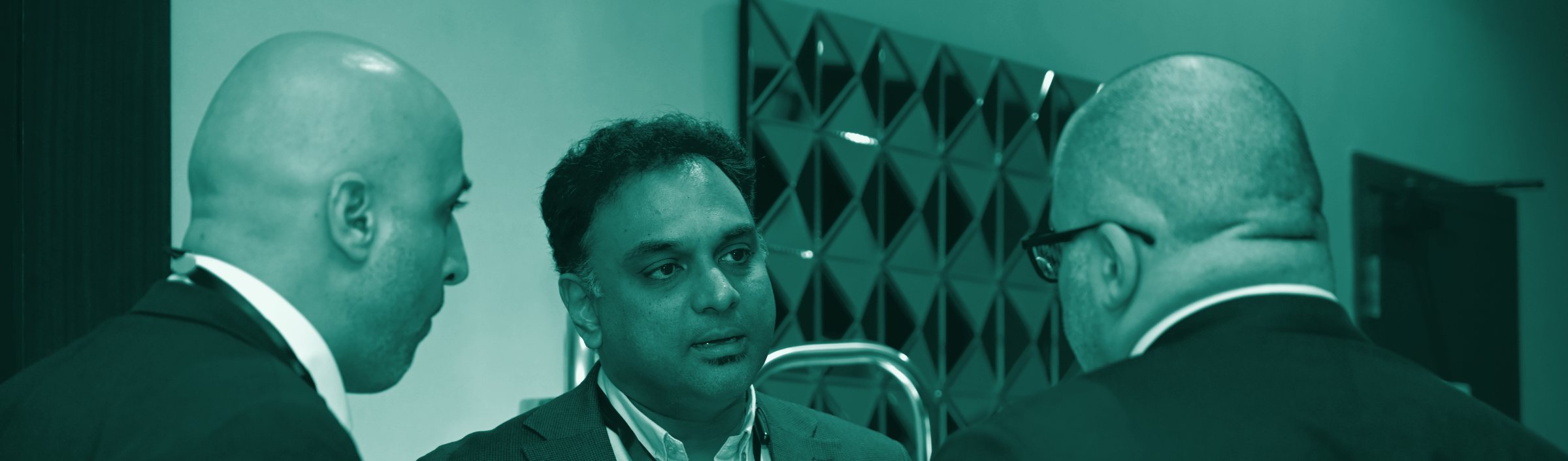 Delegates in conversation during a networking break at a VERIFY summit