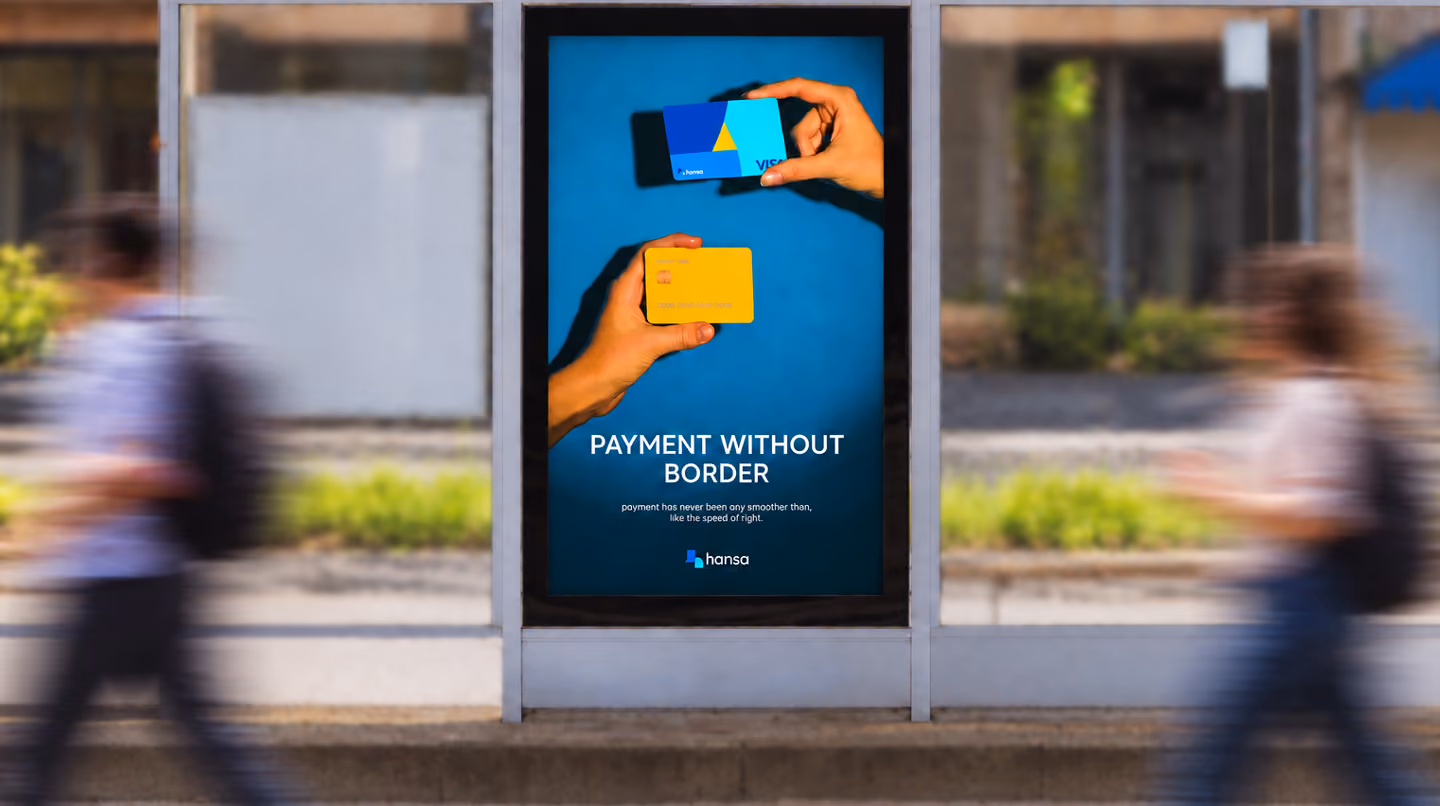 A vertical public ad display shows a blue payment card and a yellow card above the text “PAYMENT WITHOUT BORDER,” with blurred pedestrians and a street scene in the background.