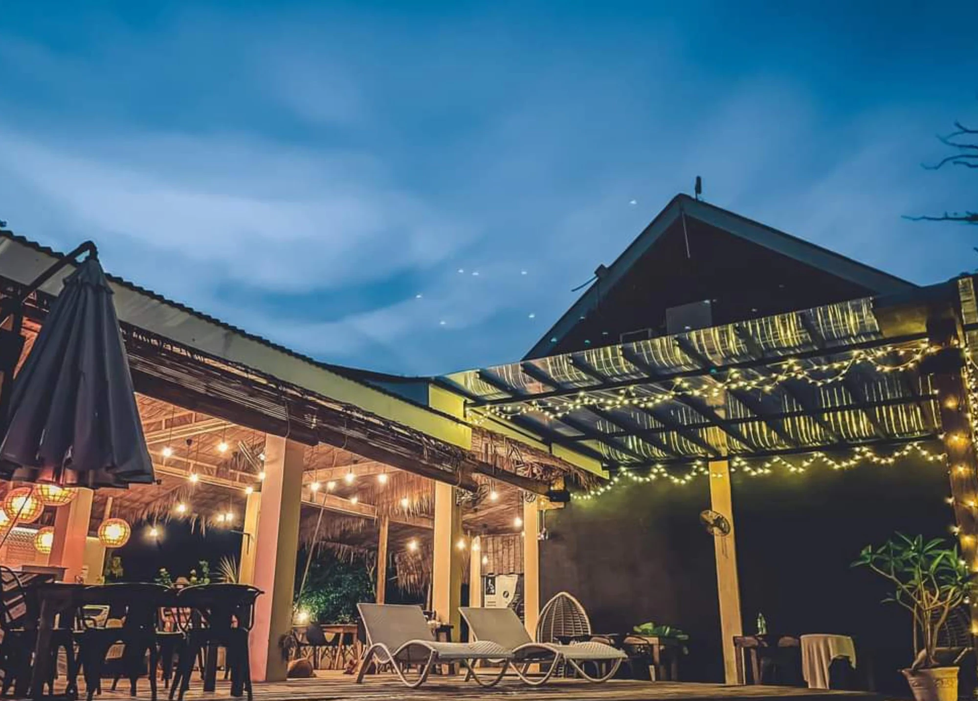 Bongo Bongo Divers terrace and restaurant lit up at dusk in Dauin