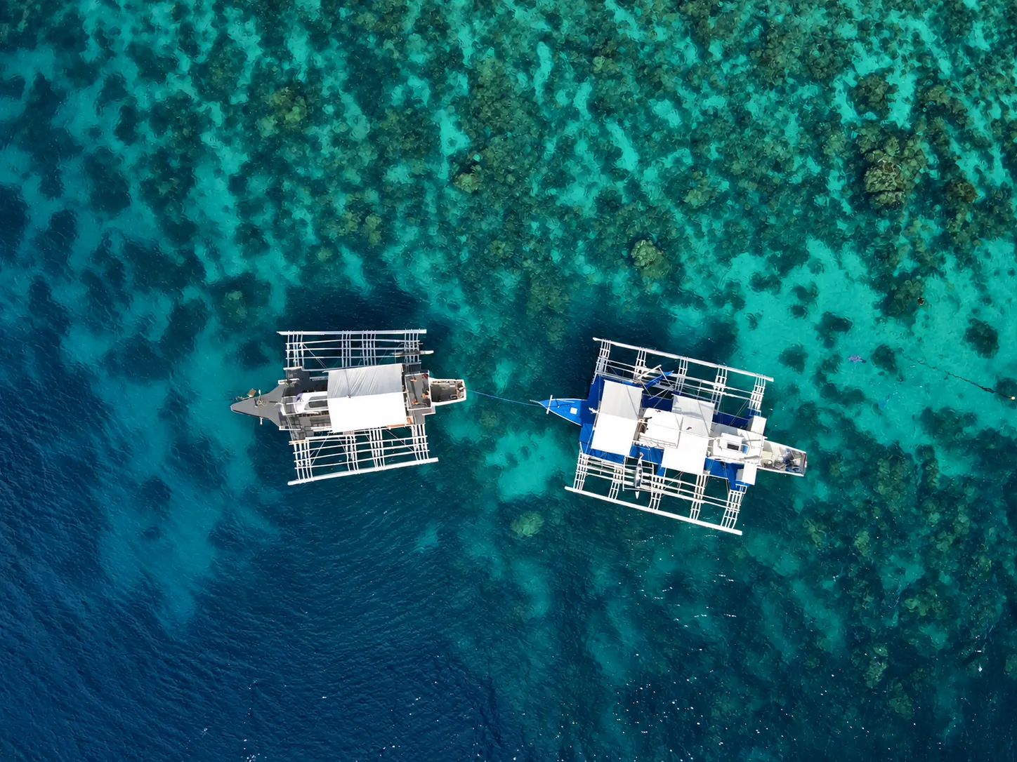 Aerial panorama of Dauin coastal villages and mountains in Negros Oriental