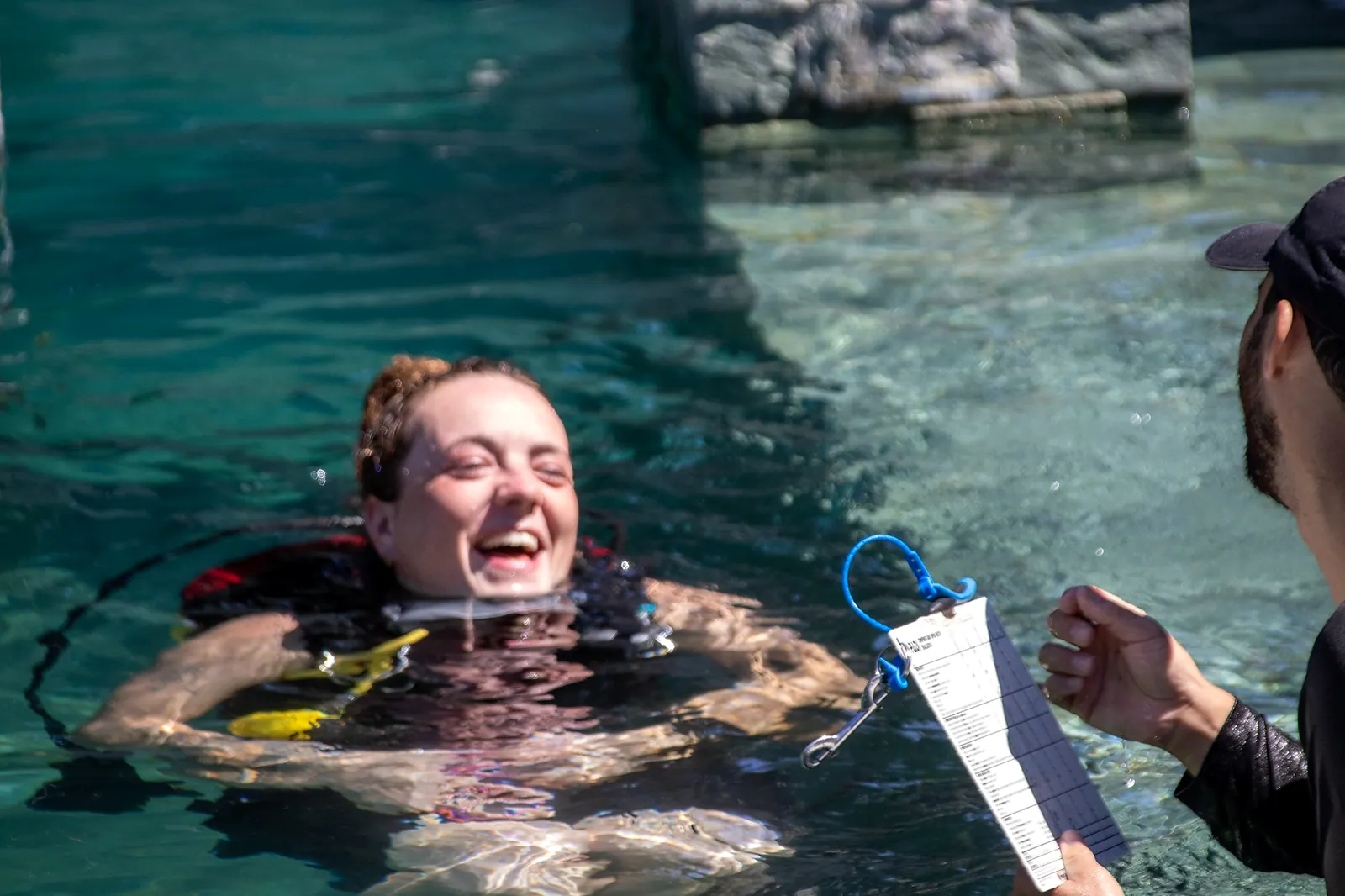 Smiling scuba student at the surface of a training pool
