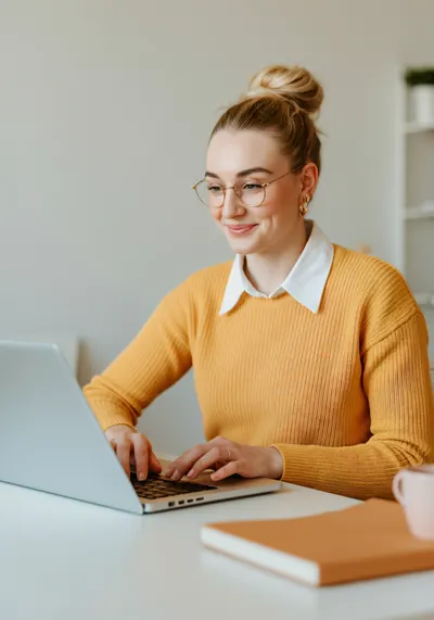 Smiling accountant working on a laptop