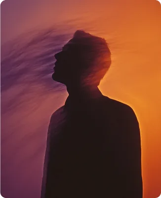 Silhouette portrait against an orange sunset
