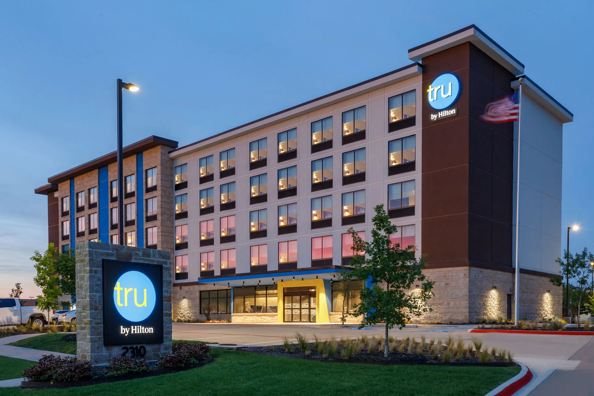 Icon Lodging hotel exterior at dusk