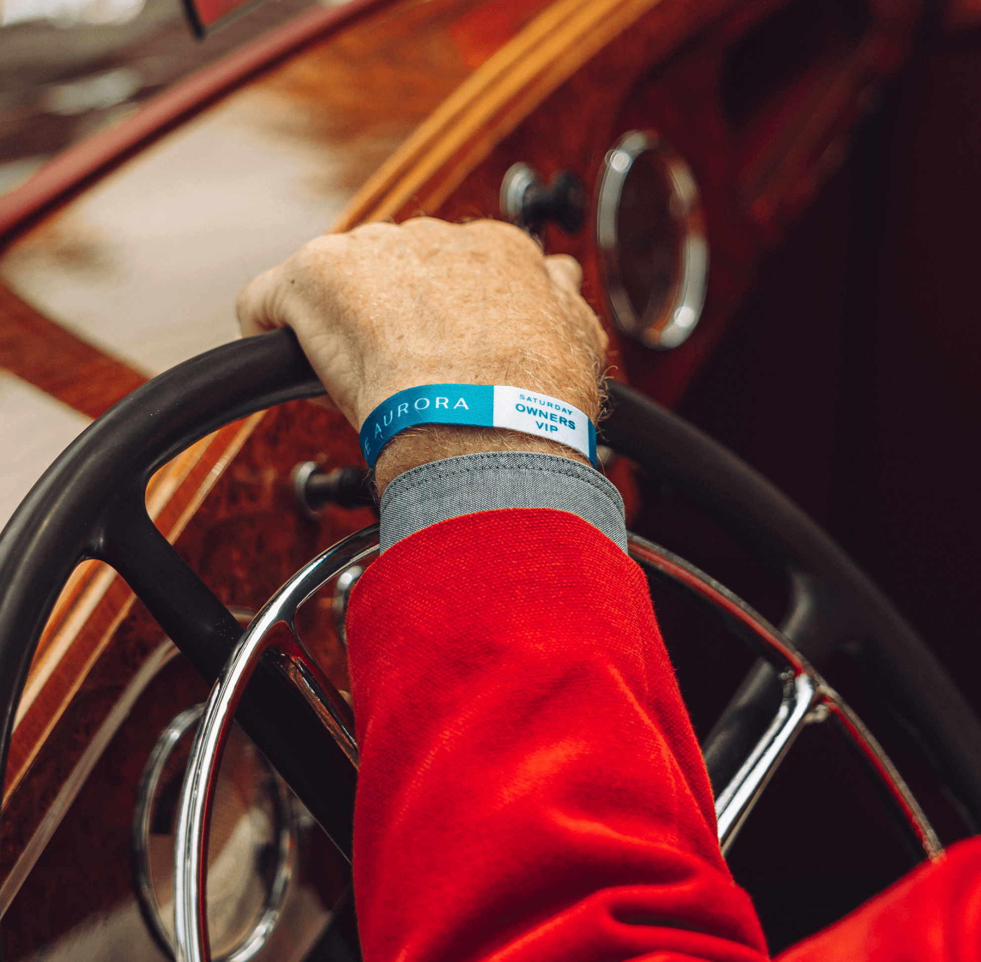 The Aurora wristband on a driver’s hand at the wheel
