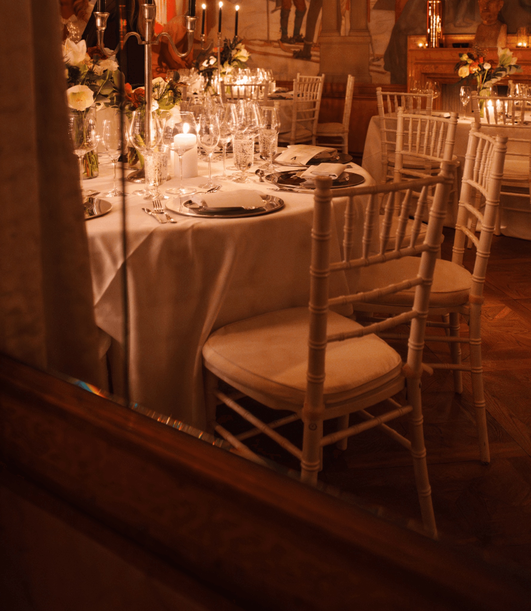 A candlelit dining room set for dinner at A Family Club