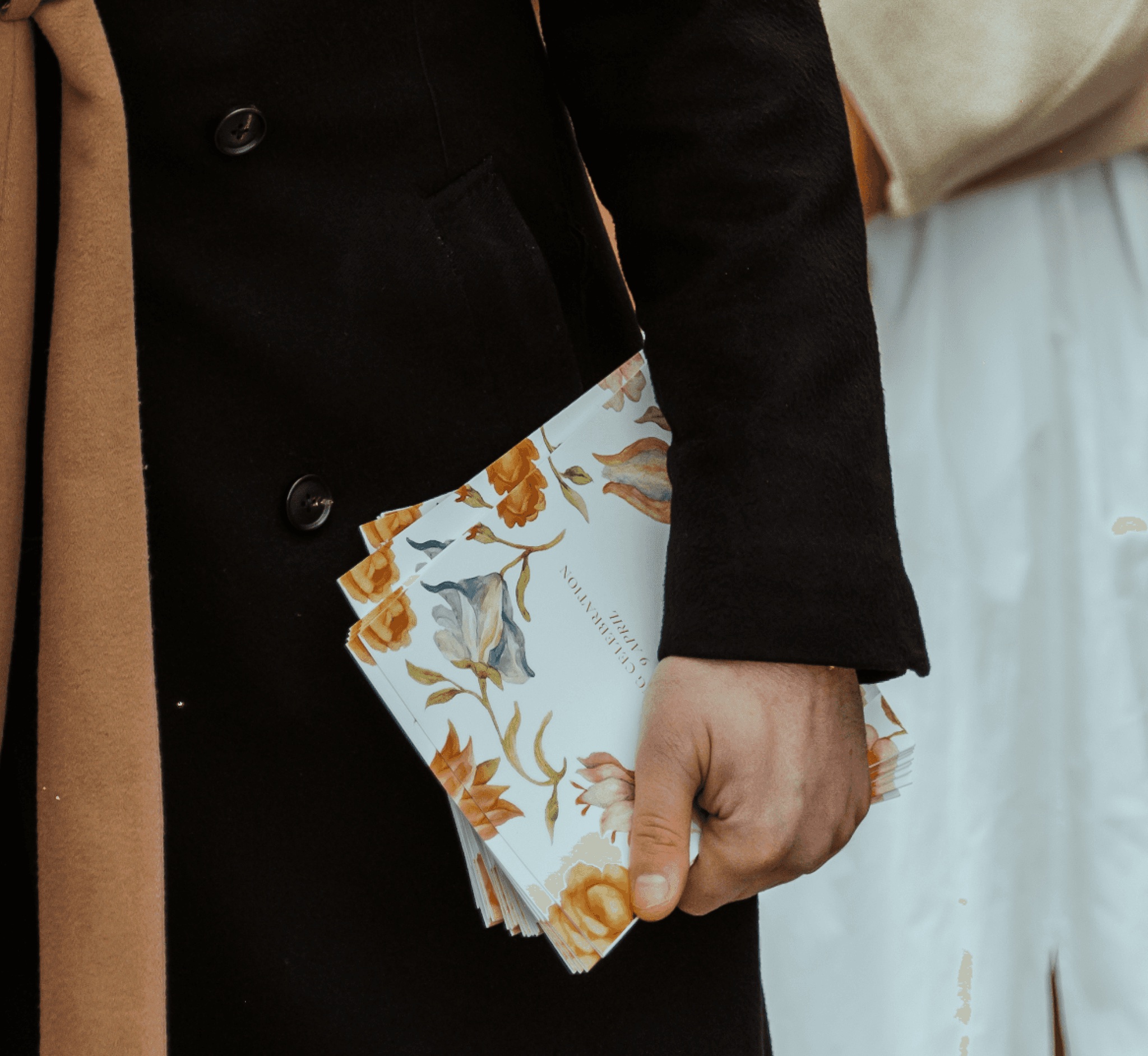 A guest holding floral A Family Club printed menus