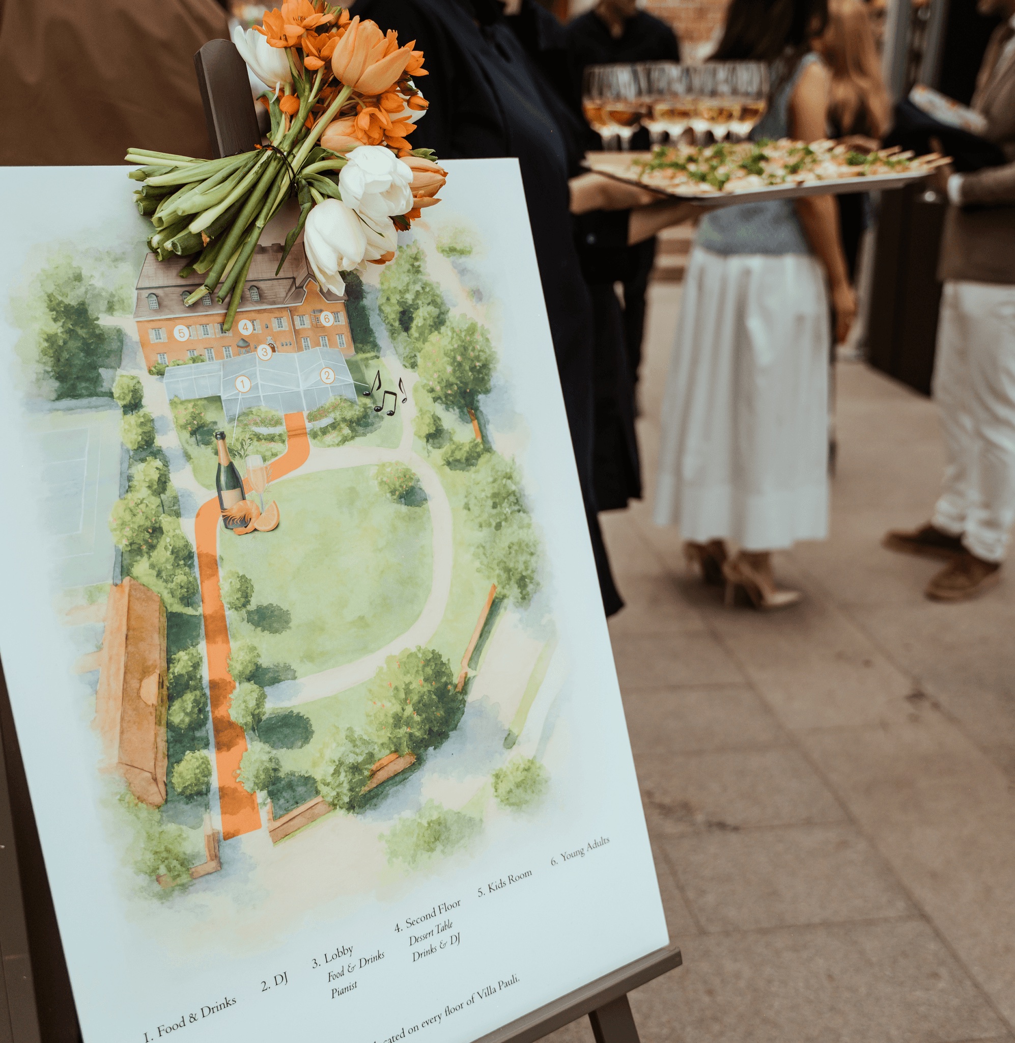 An illustrated A Family Club estate map on an easel at a garden event