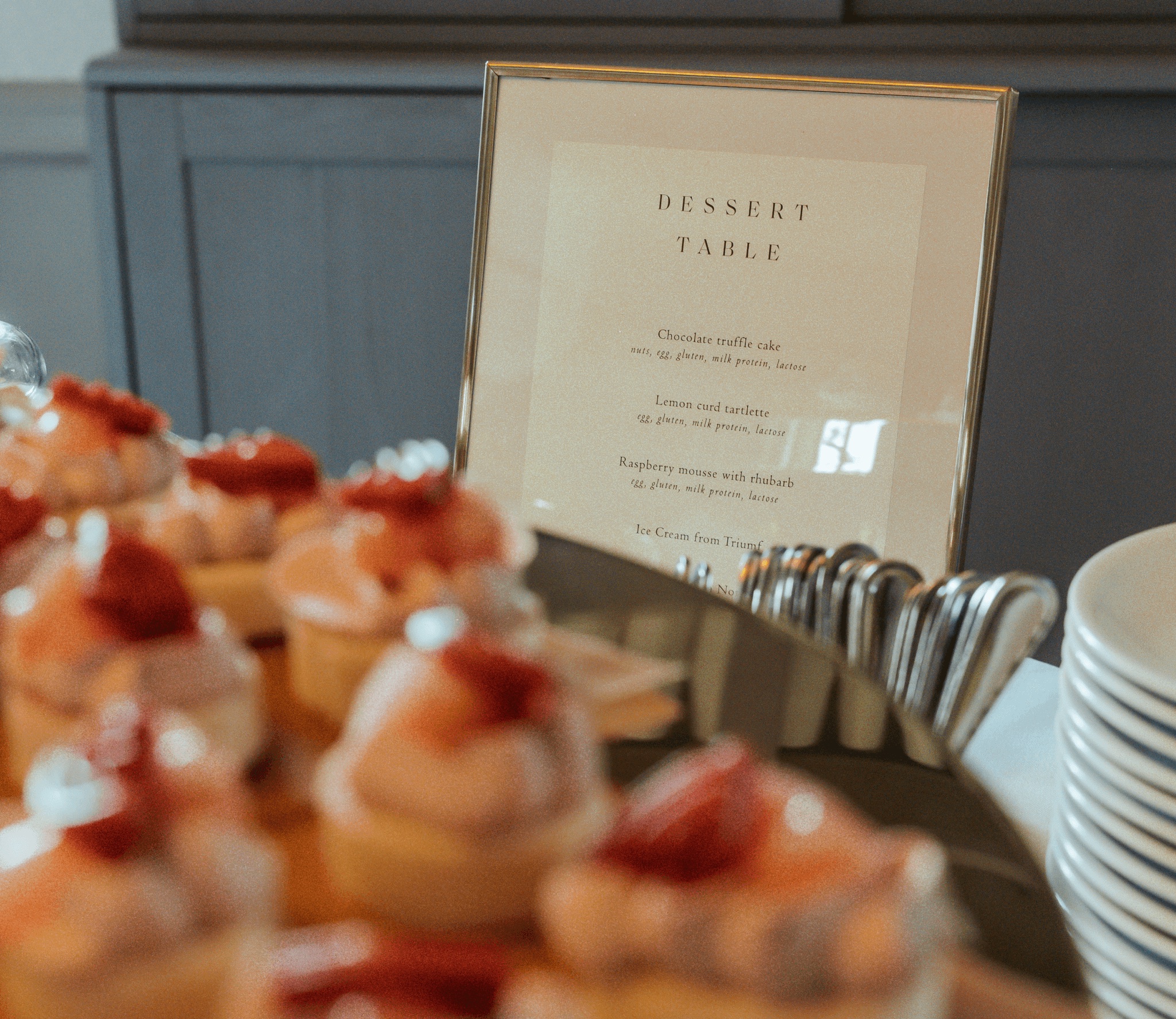A dessert table with an A Family Club menu sign