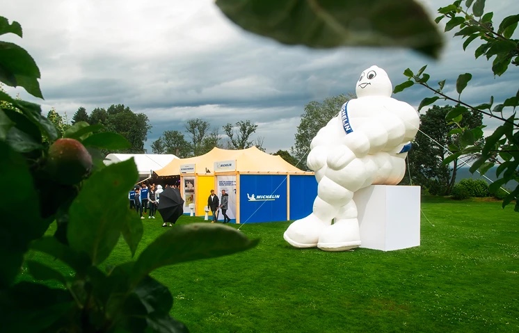 A giant Bibendum sitting on the lawn beside the Michelin pavilion