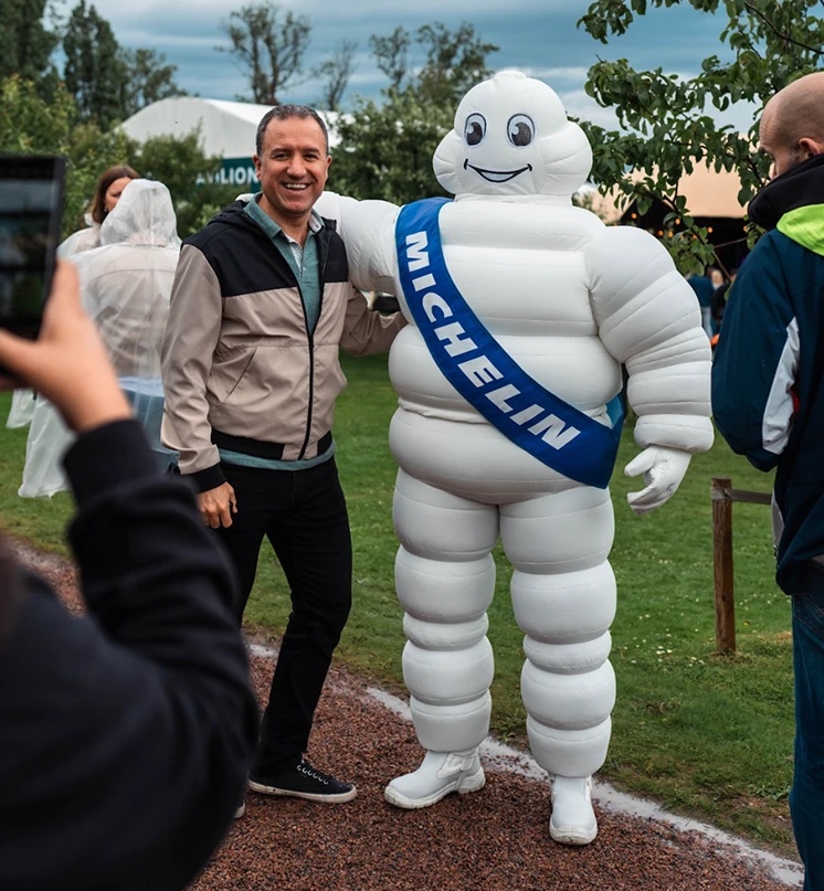 A guest posing with Bibendum for a photo