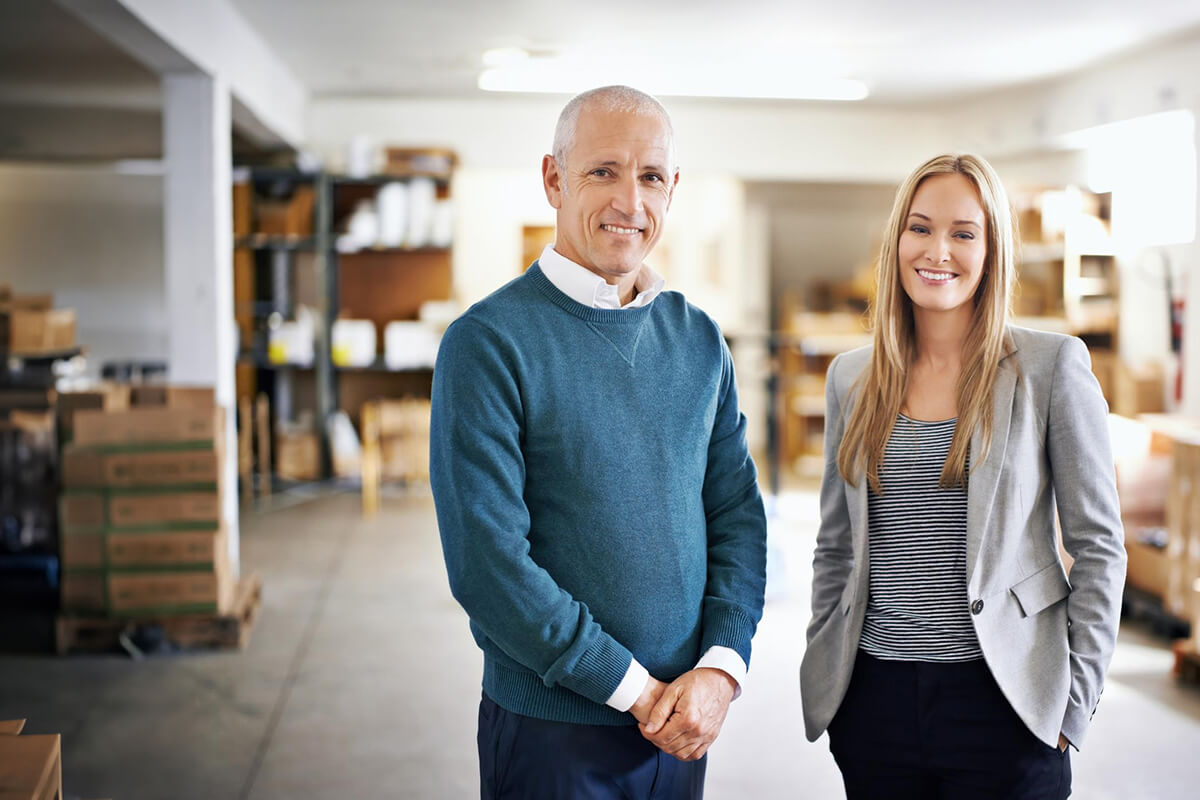 Two business owners standing together in their company's warehouse