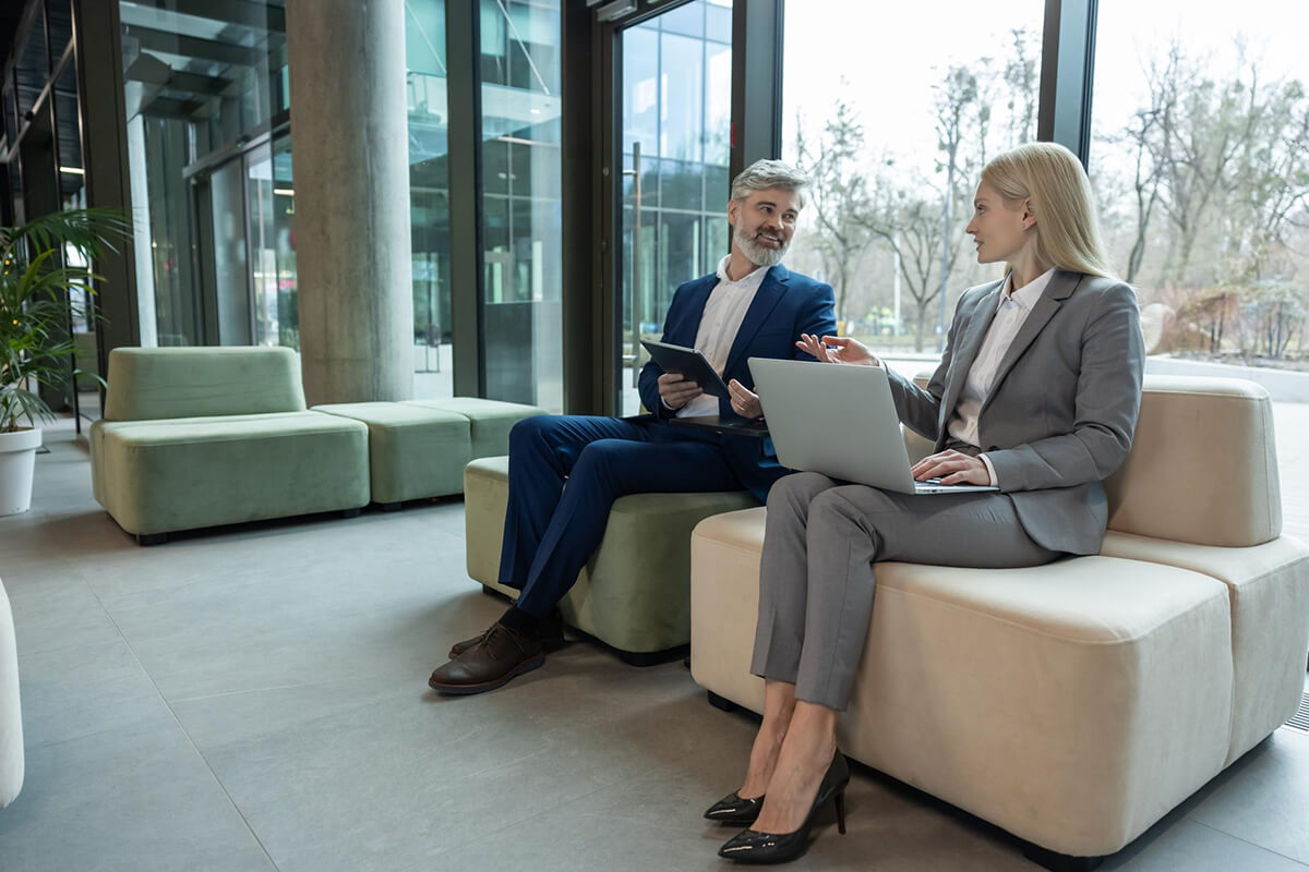 A physician and a clinical colleague meeting with an adviser across a conference table