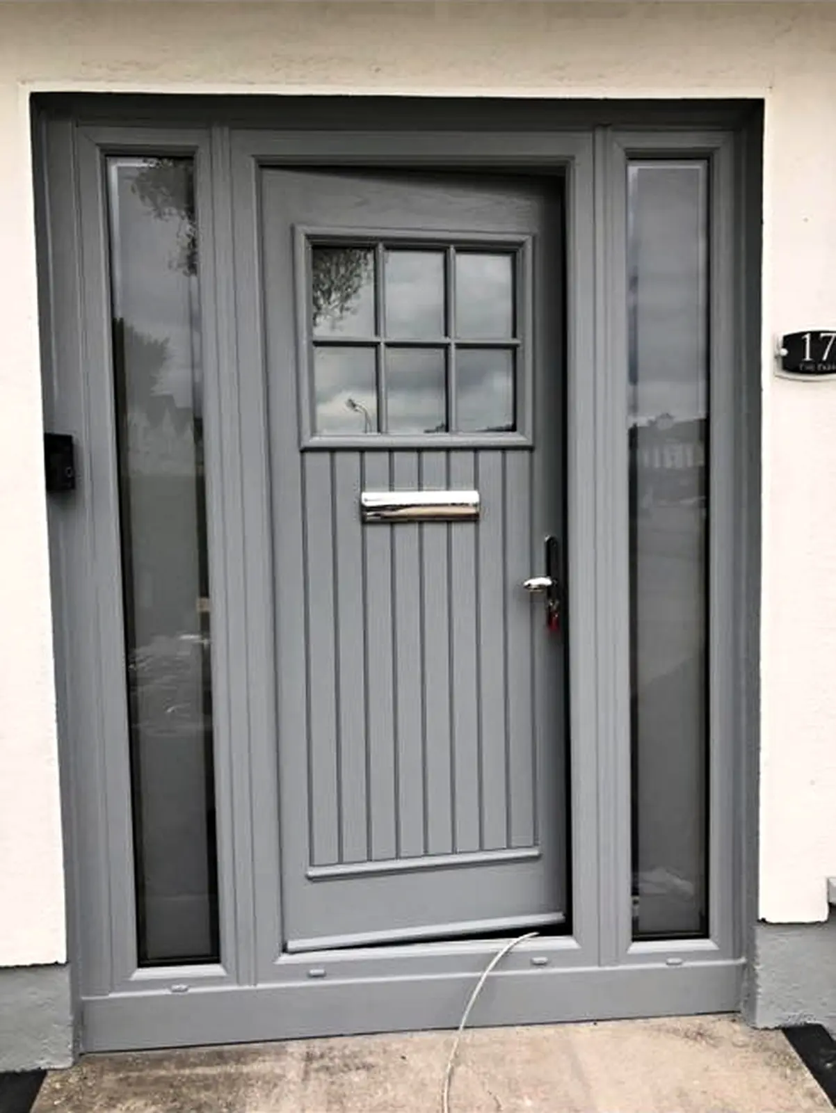 Grey front door and sidelights after spray painting