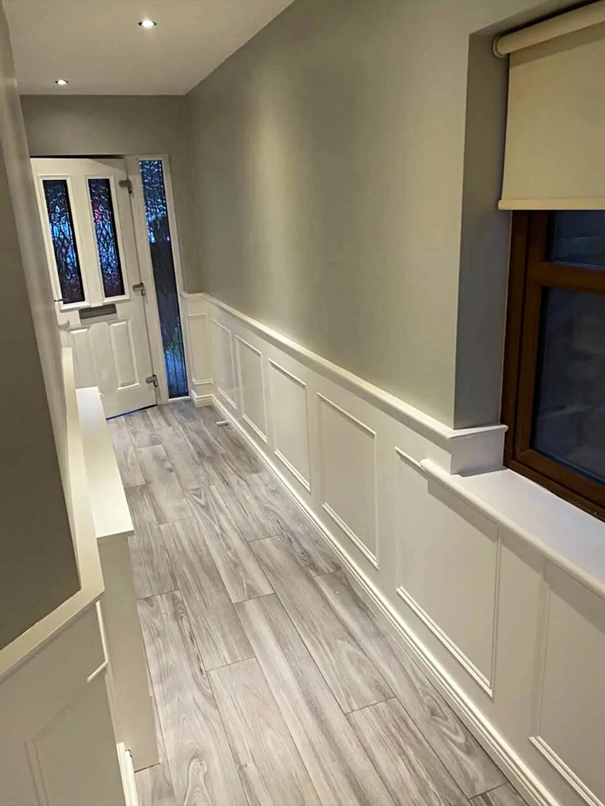 Finished hallway with white painted timber panelling