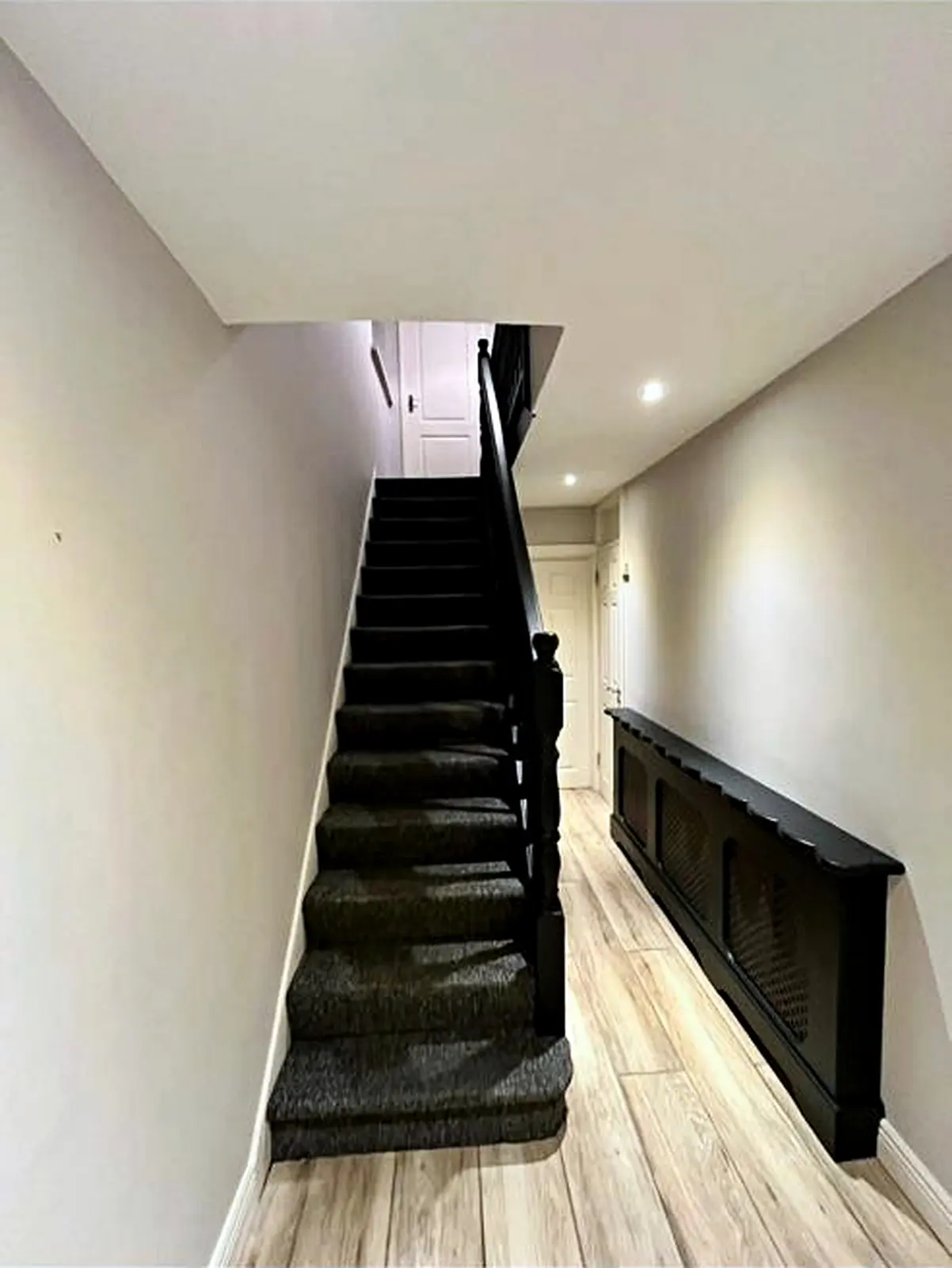 Finished residential hallway with painted walls and dark woodwork