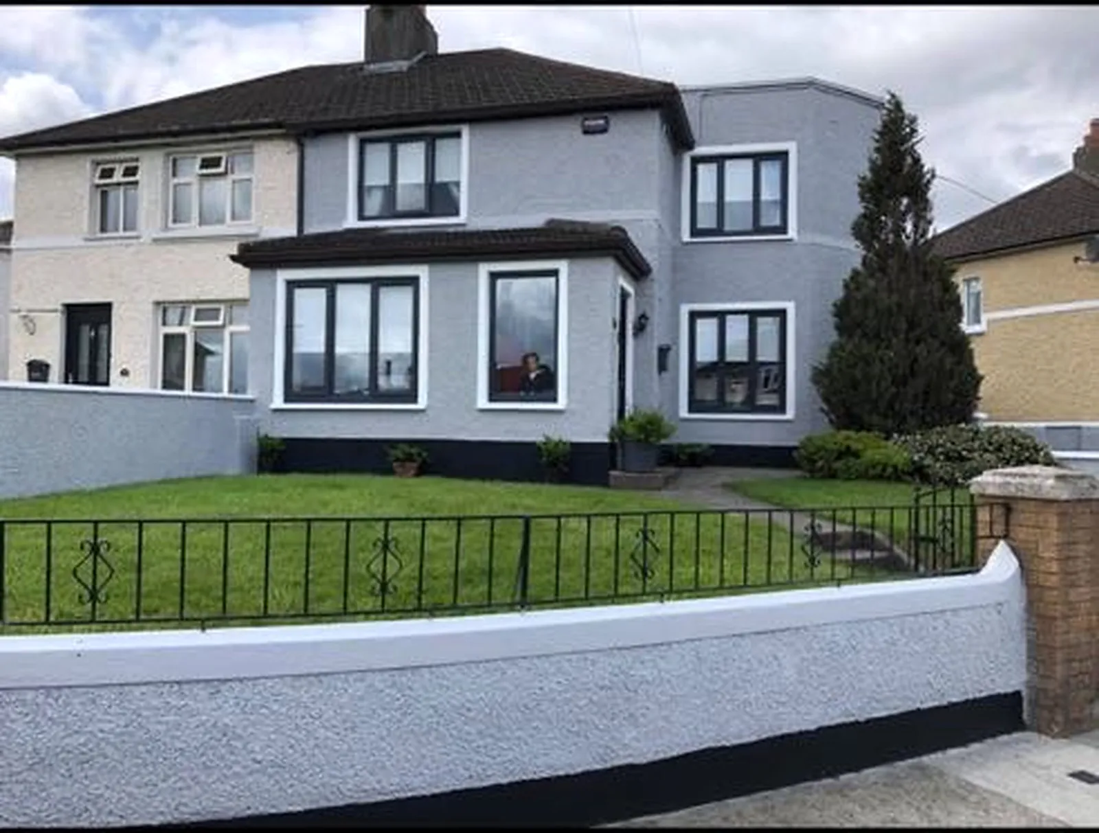 Completed residential exterior repaint in grey with white and dark accents