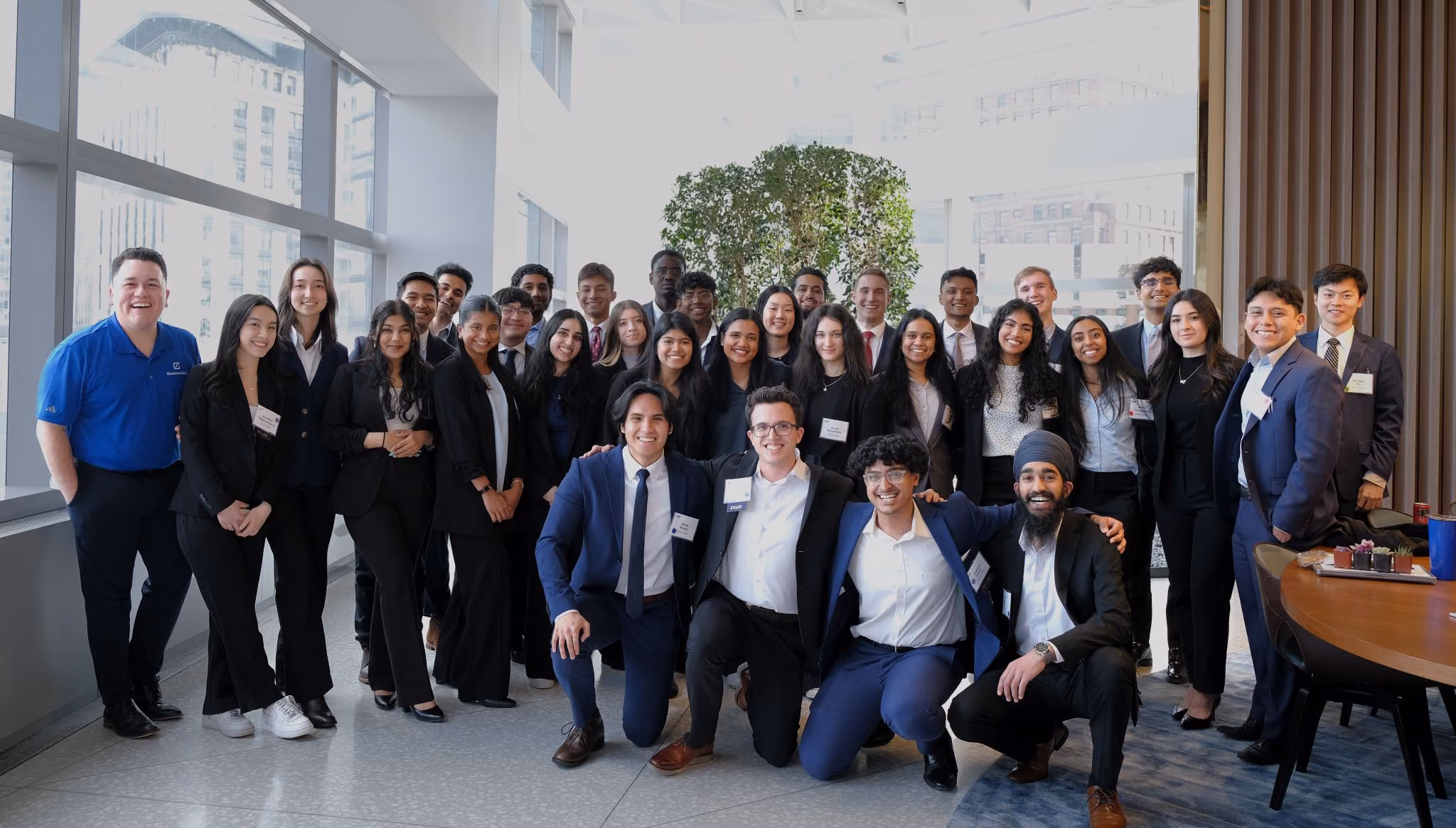 Group photo of Rutgers Scholars of Finance students in business attire inside an office building