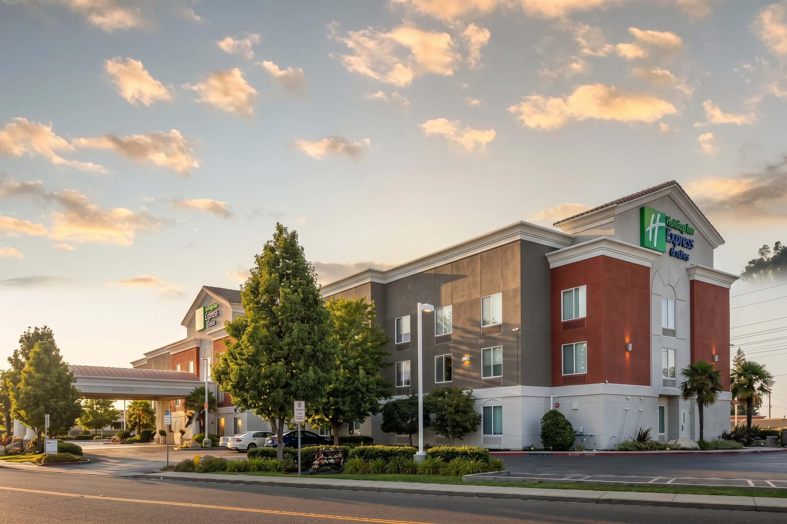 Holiday Inn Express and Suites Modesto at golden hour with Sierra foothills behind