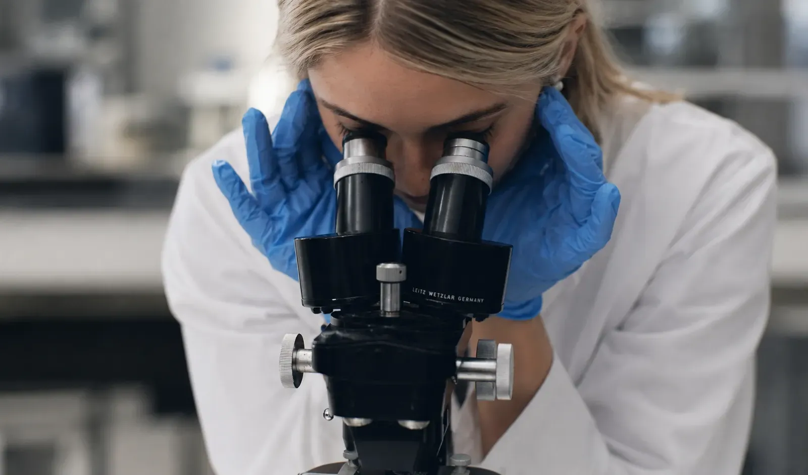 A scientist examining a complex formulation under a microscope