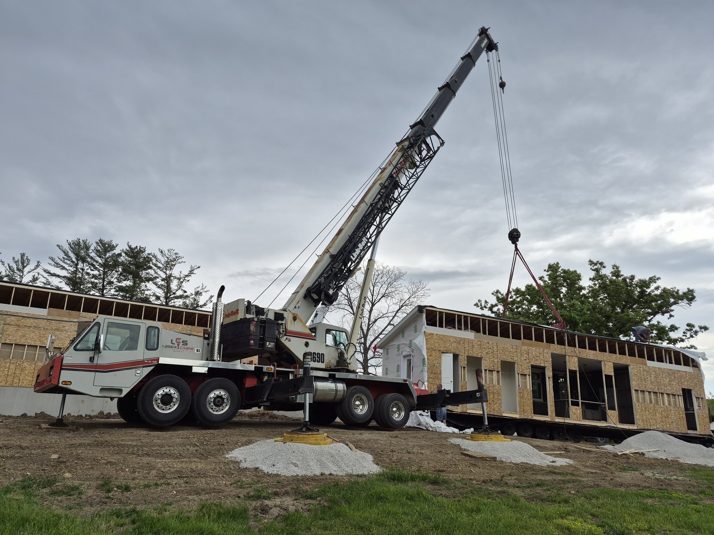 Crane setting a modular home section