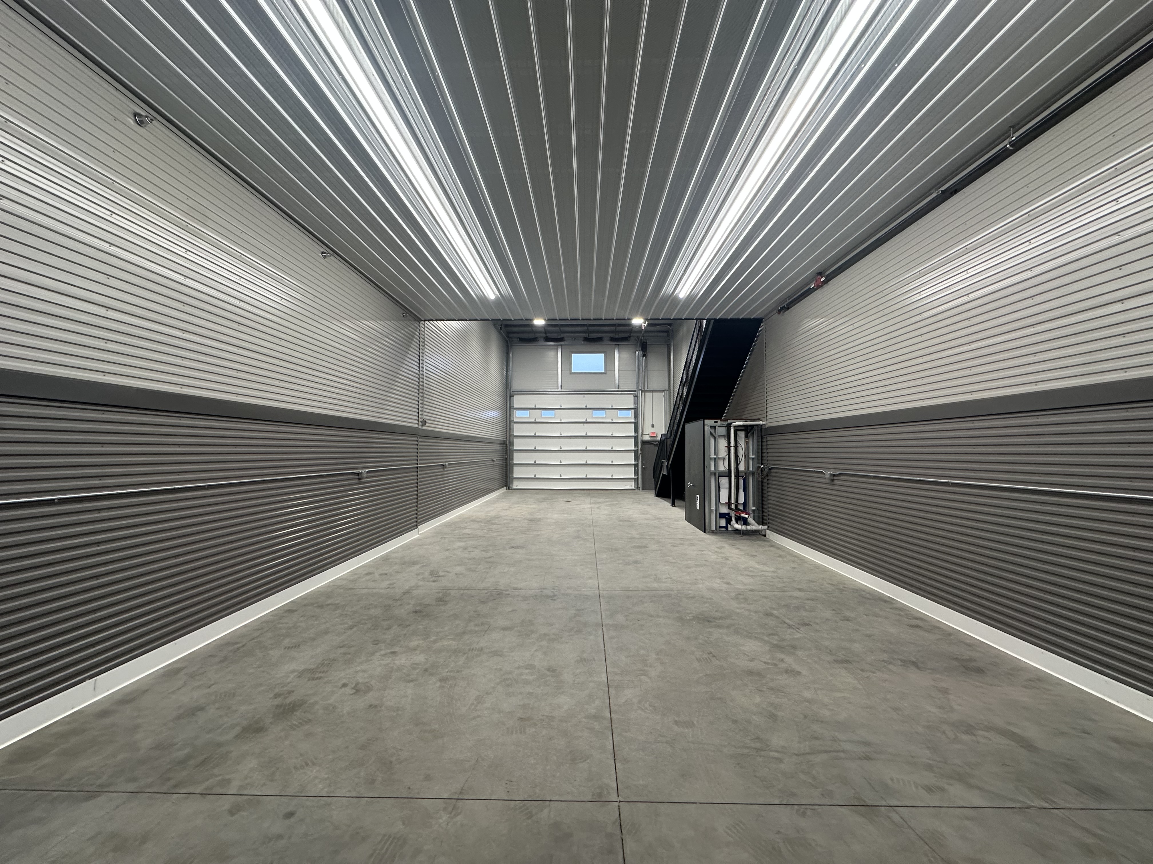 Standard 24x70 Woodbury interior under mezzanine facing overhead door