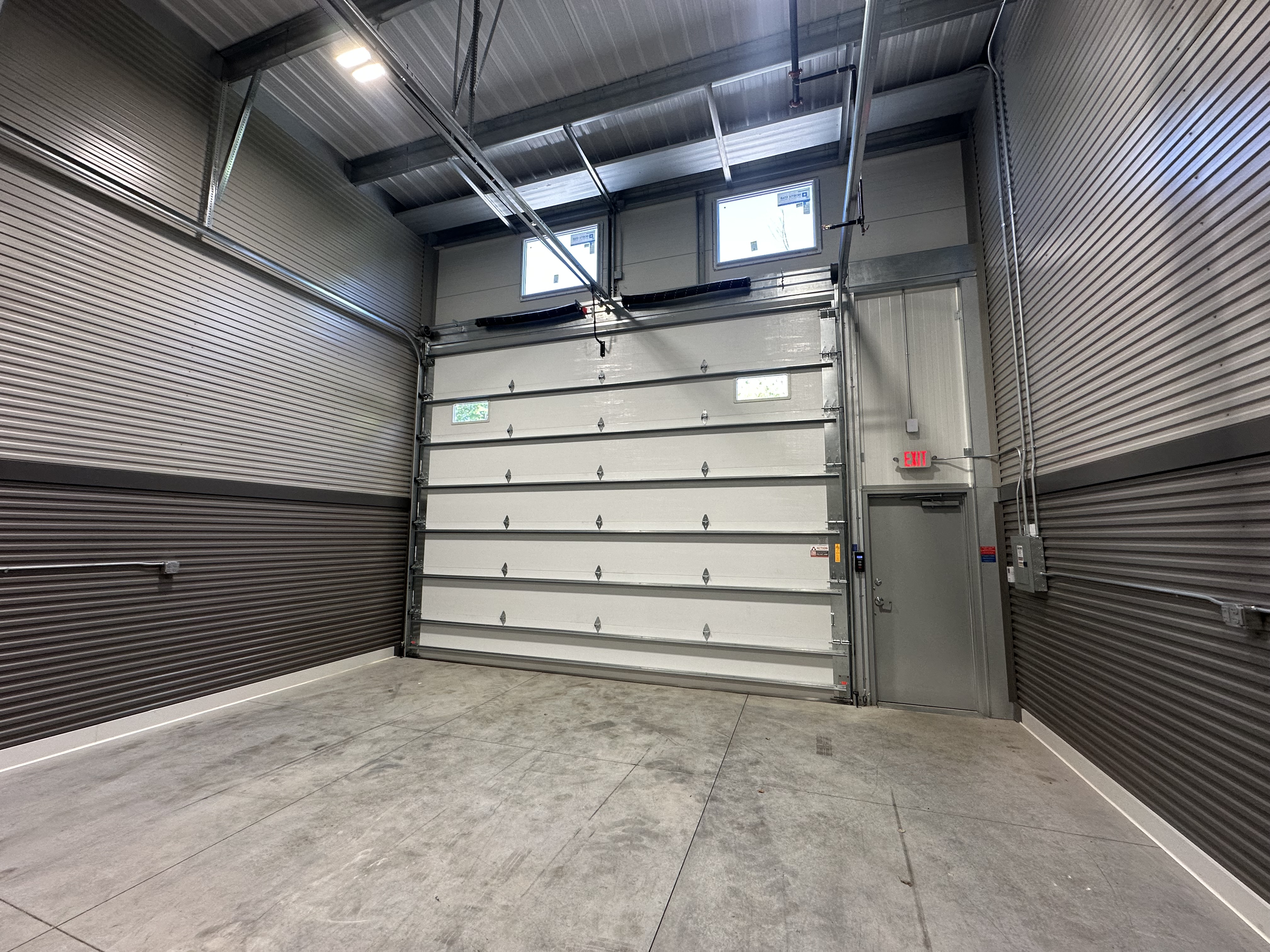 Standard 24x100 Prior Lake overhead door and service door from inside