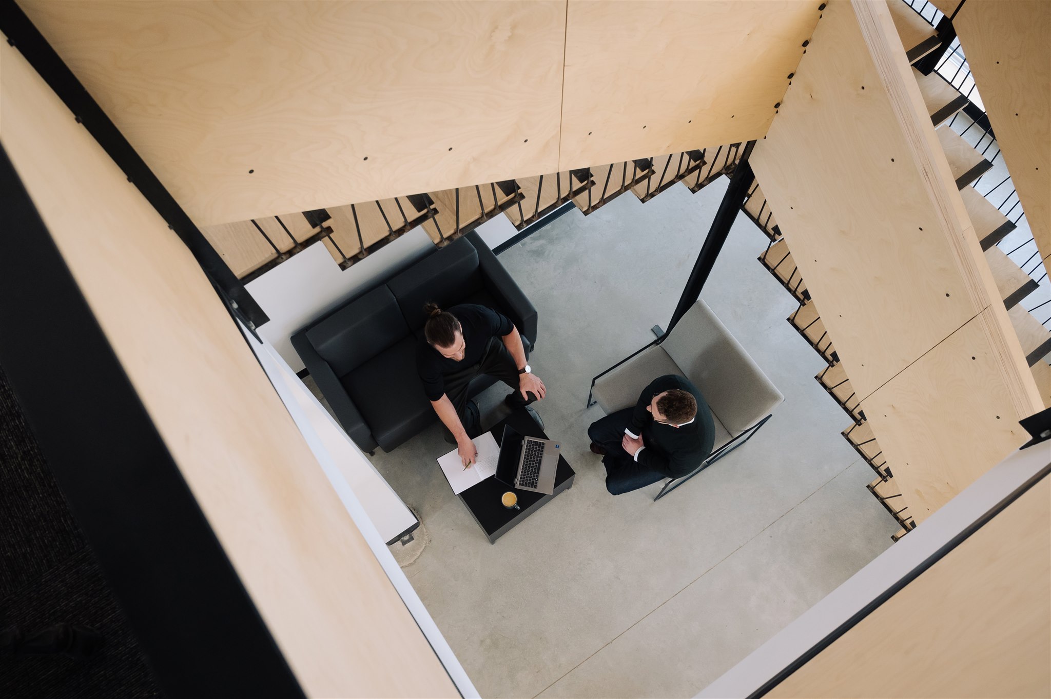 Photo of two people having conversation in office environment