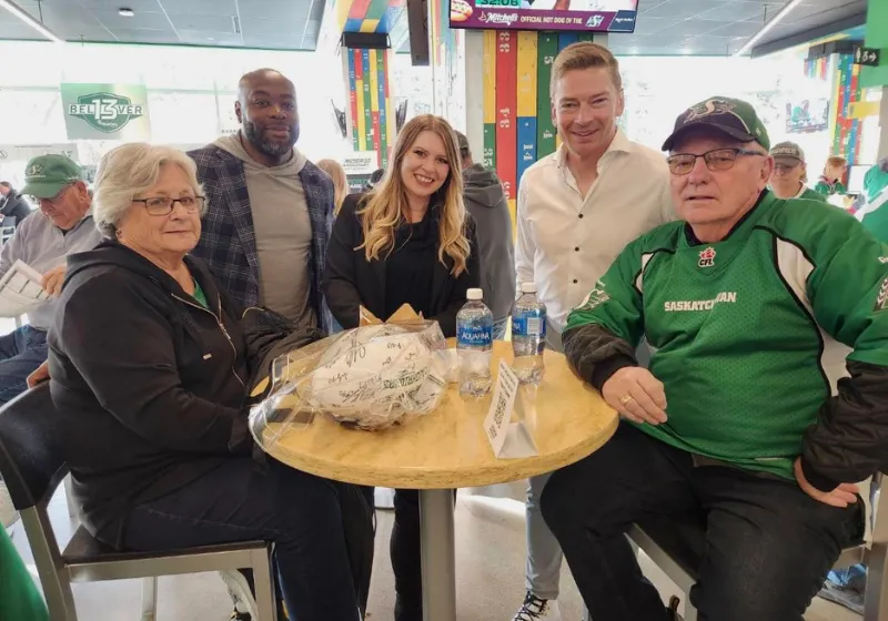 Fans and Harvard Media hosts around a table at a live event