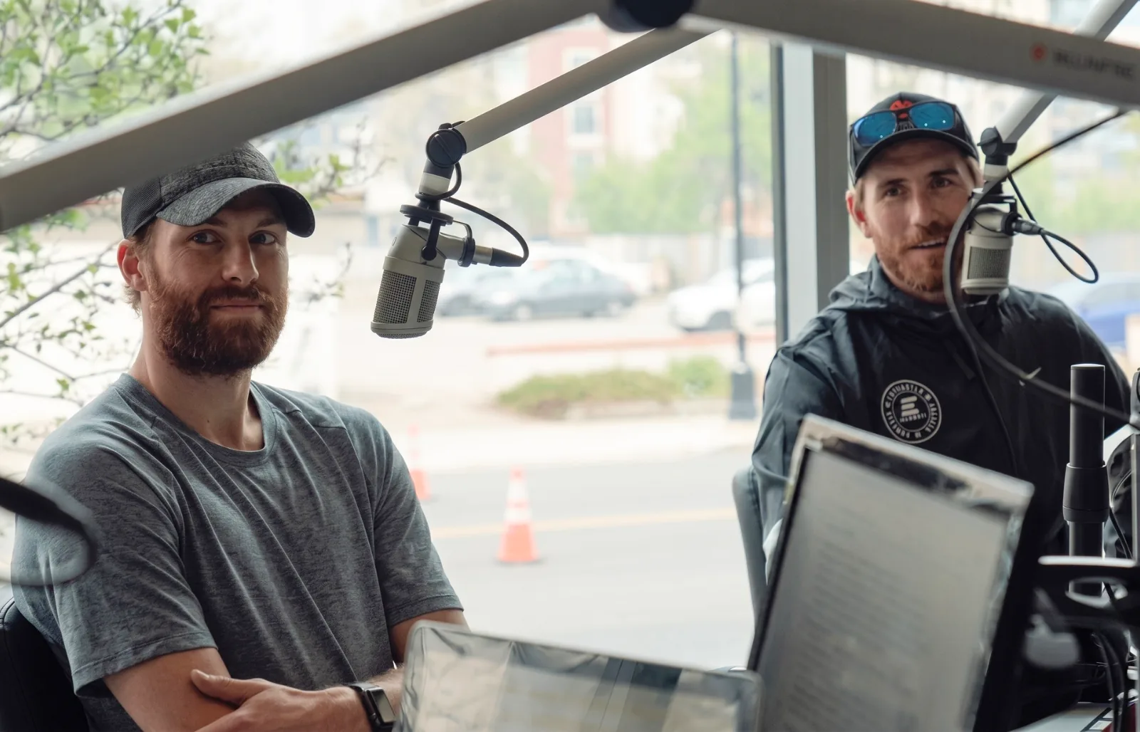 Two hosts recording in a studio