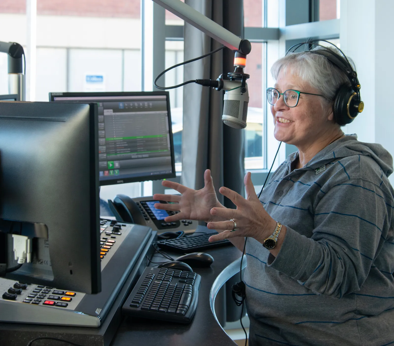 620 CKRM host speaking into a microphone in the radio studio