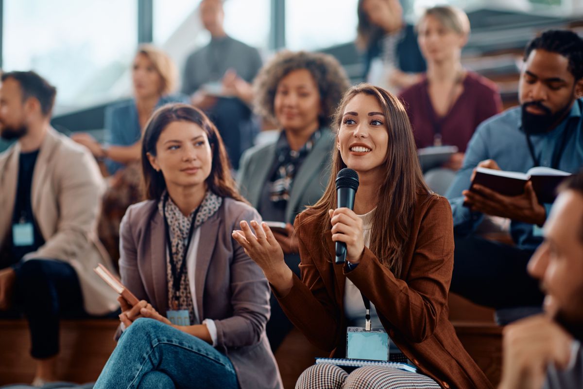 A participant speaking into a microphone during an interactive session