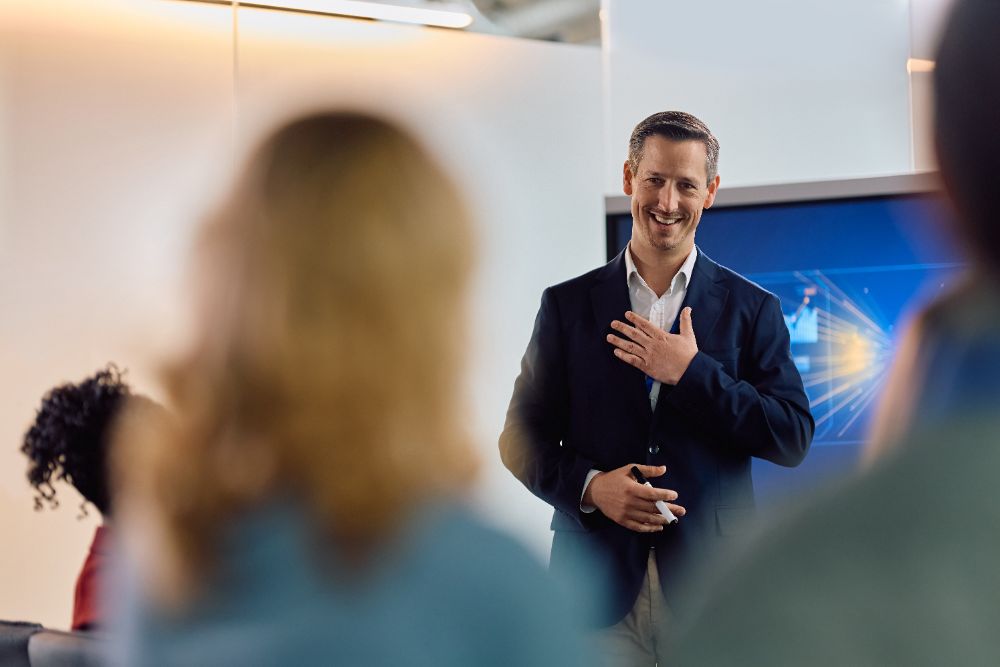 A leader presenting to colleagues in a meeting room