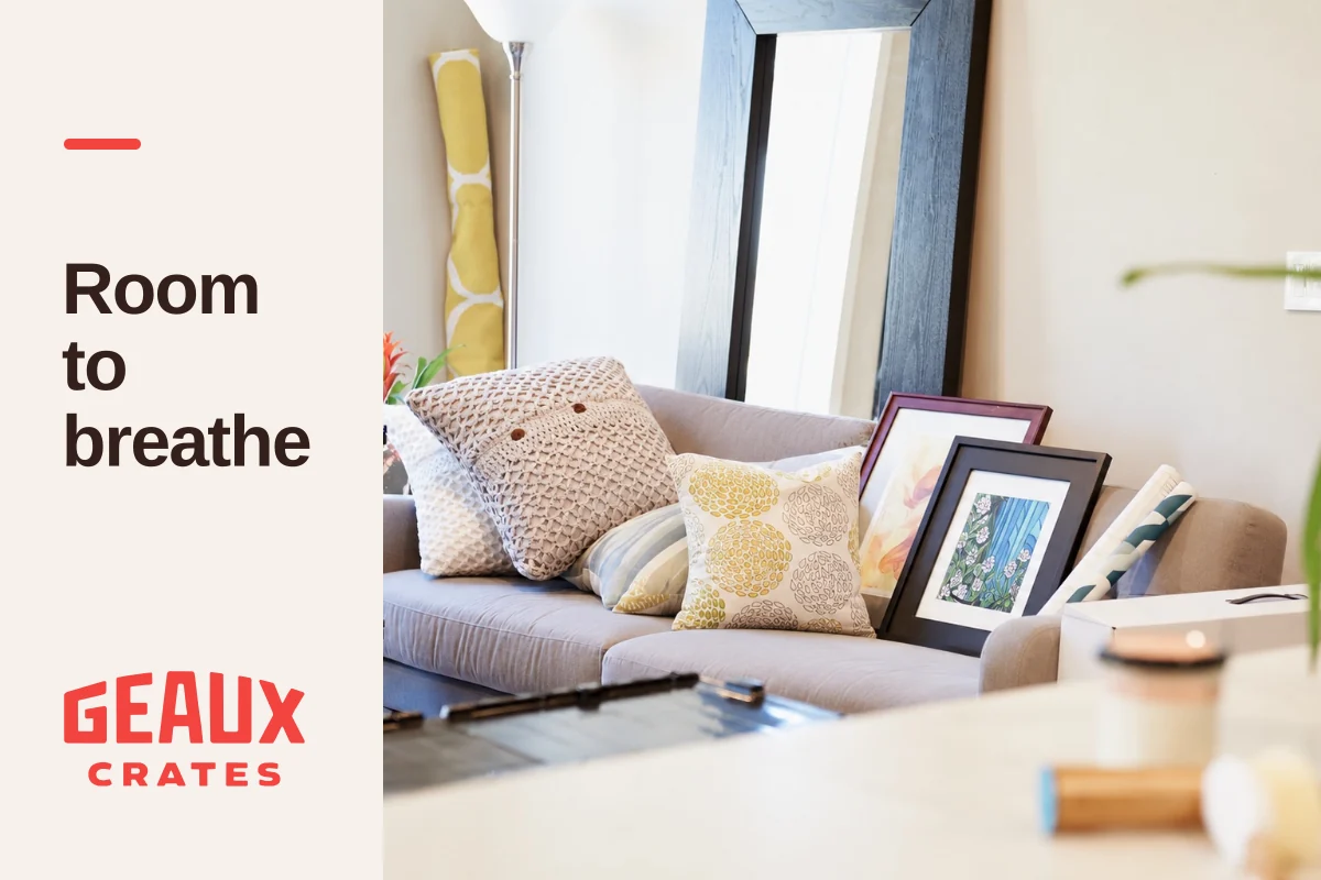 Bright living room with sofa and framed artwork beside “Room to breathe” and the Geaux Crates logo.