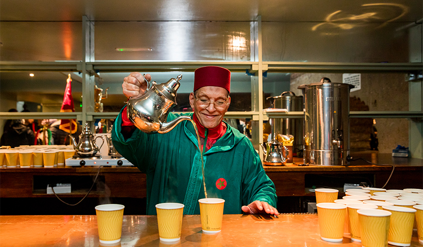 Bartender pouring a drink at a lively venue