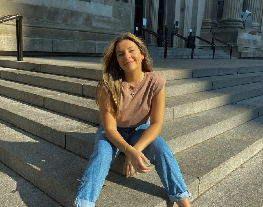 Giulia Guerrieri sitting on city steps