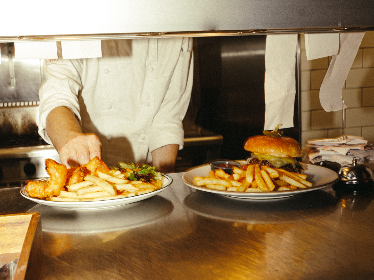 Chef preparing pub lunches at the kitchen pass