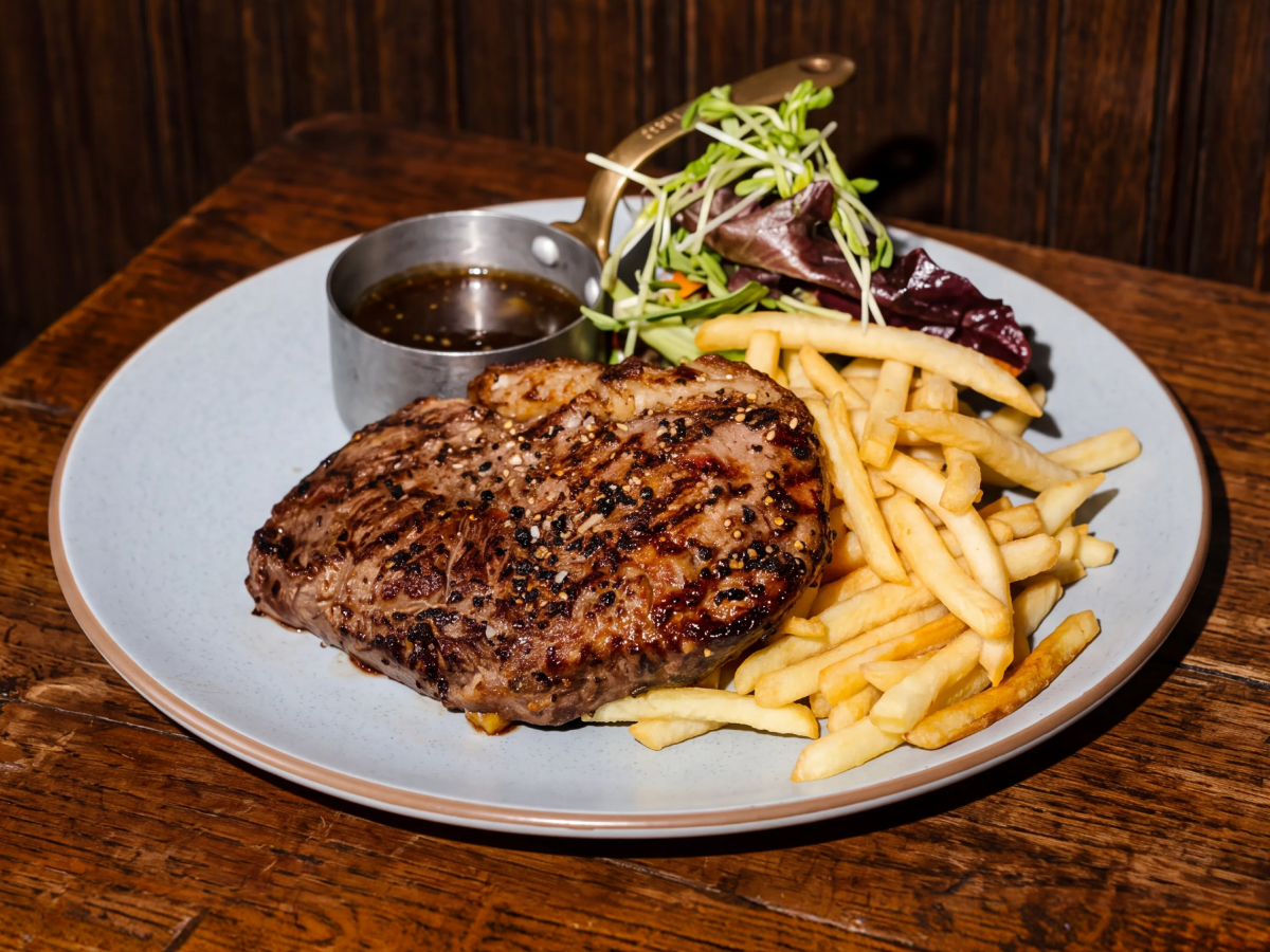 Steak with chips, salad and pepper sauce
