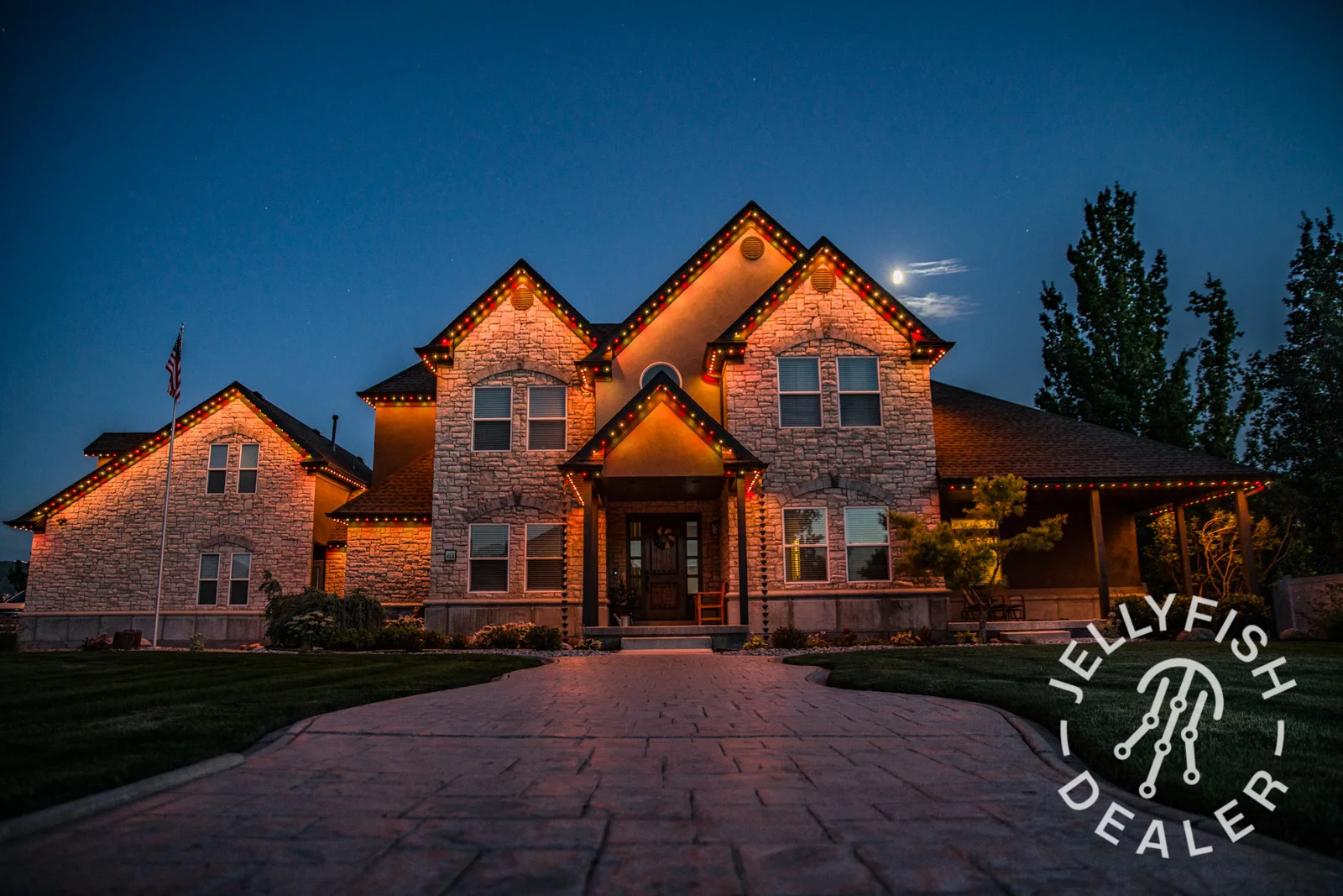 Warm amber lighting across a home’s roofline.