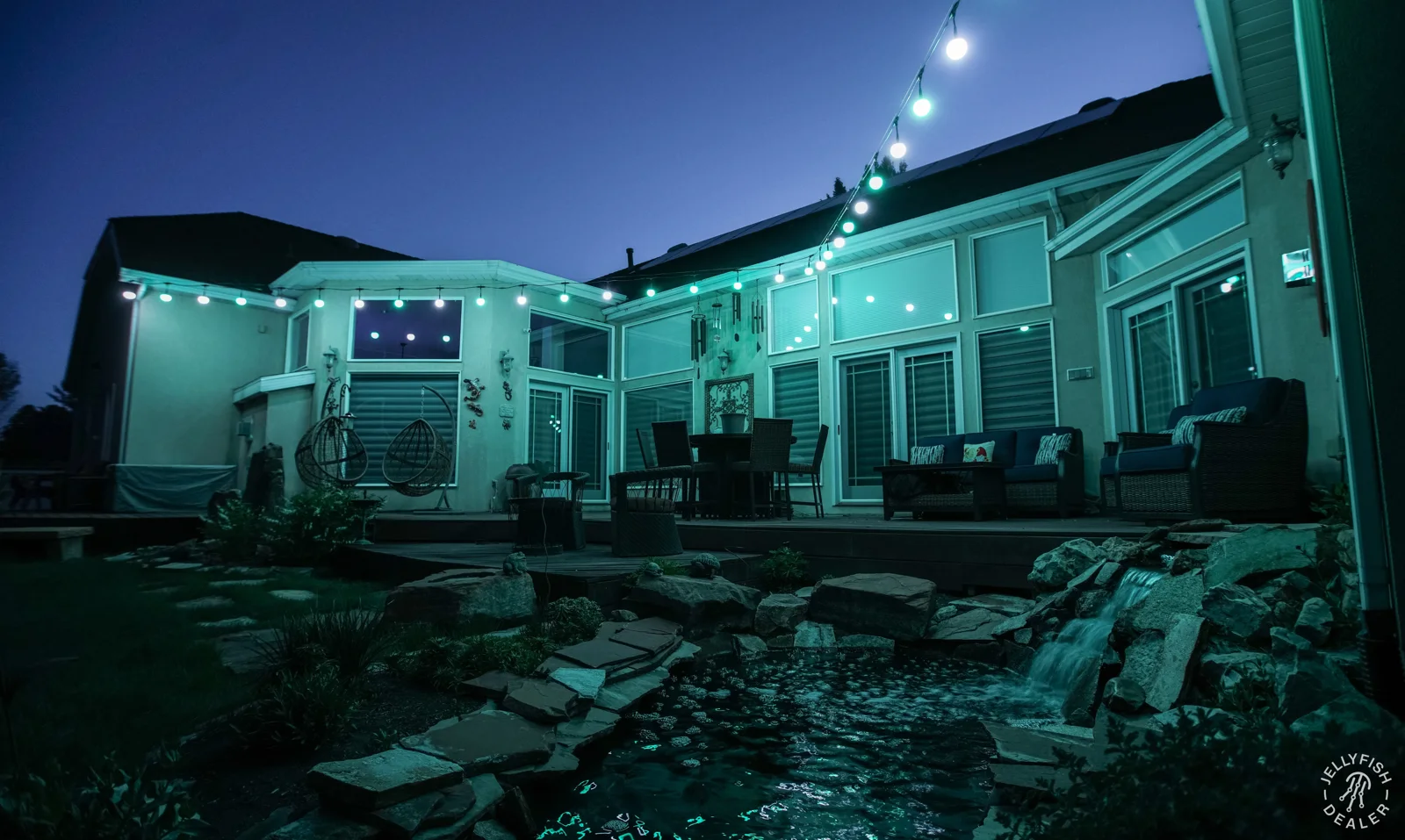 Colorful patio string lighting above an outdoor seating area.