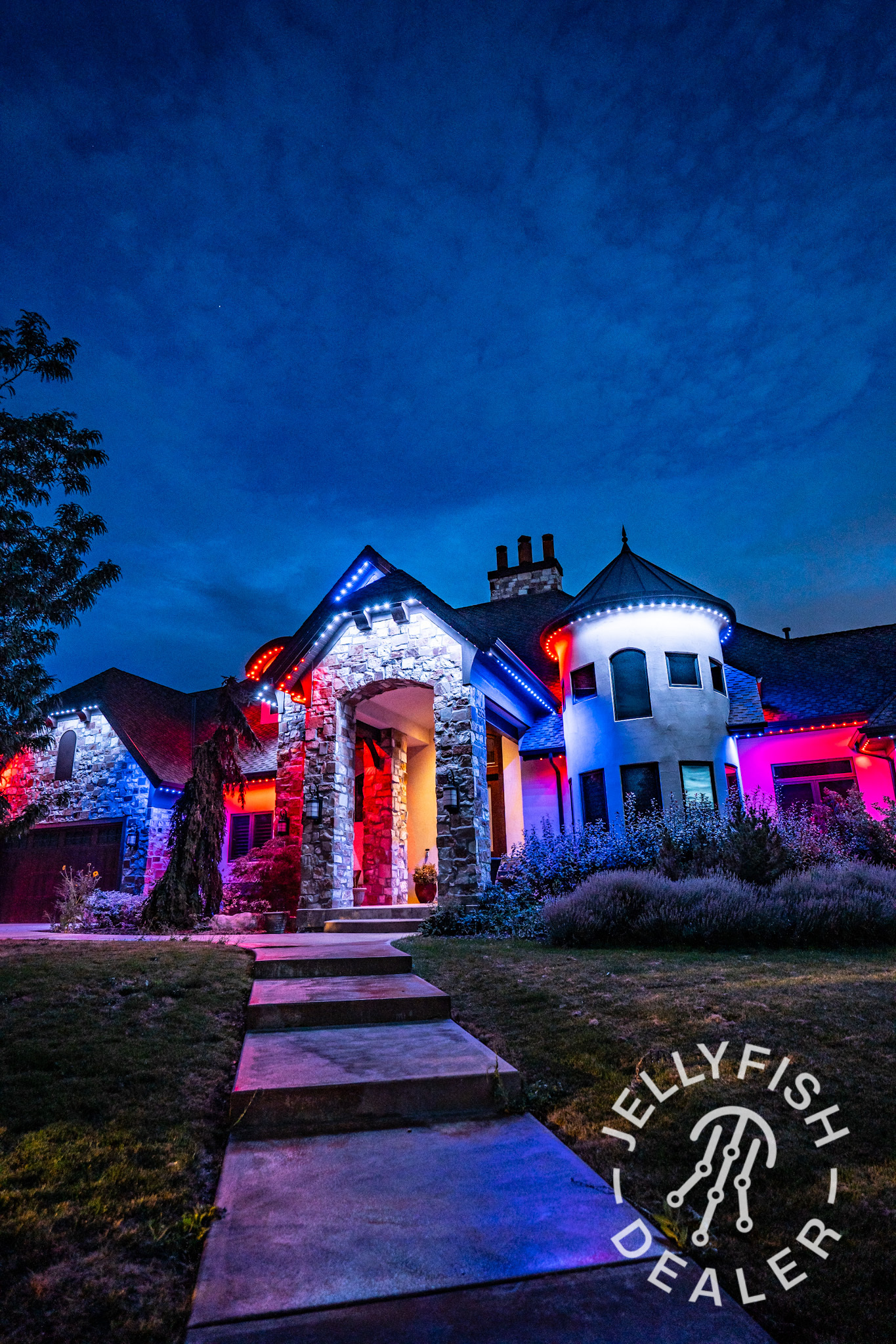 Red, white, and blue permanent outdoor lights on a home.