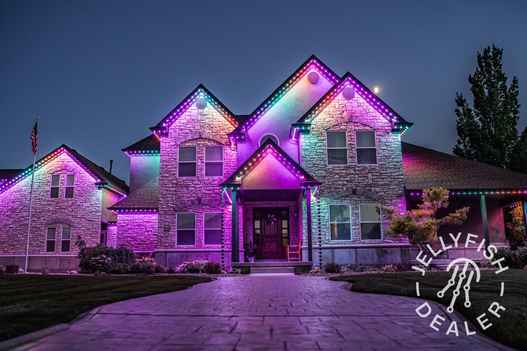 Multicolor celebration lighting on a two-story home.