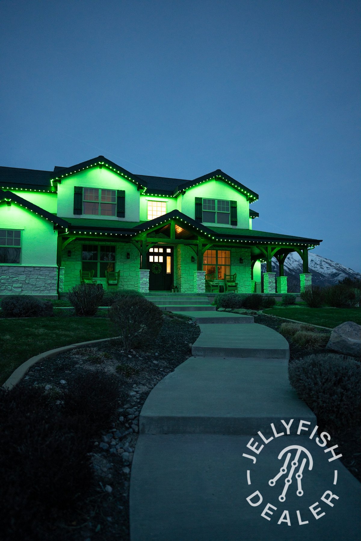 Green lighting across a two-story home.
