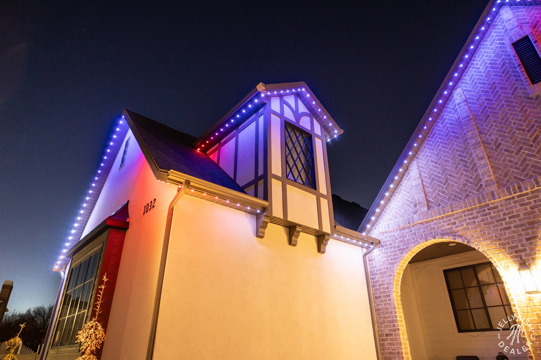 Red, white and blue lighting along a brick courtyard.