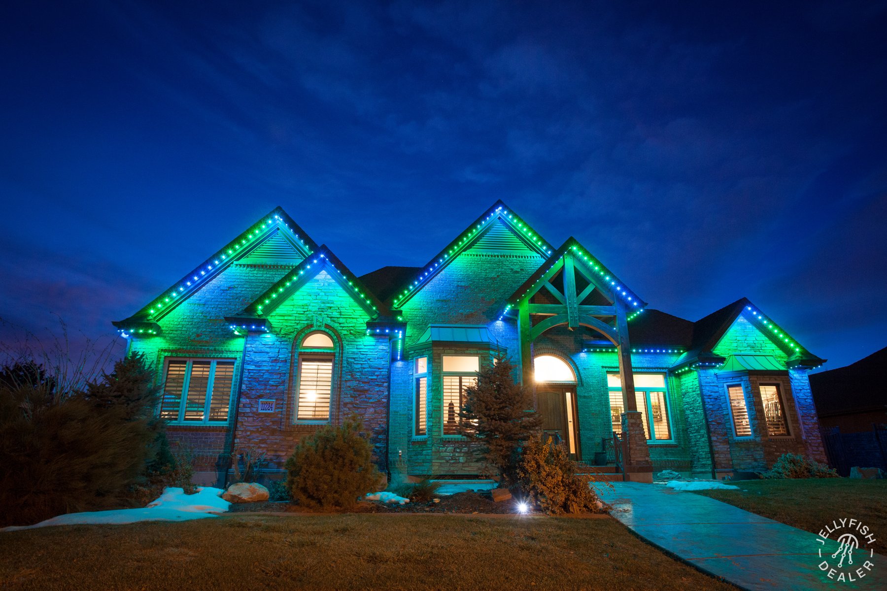 Blue and green game-day lighting on a home.