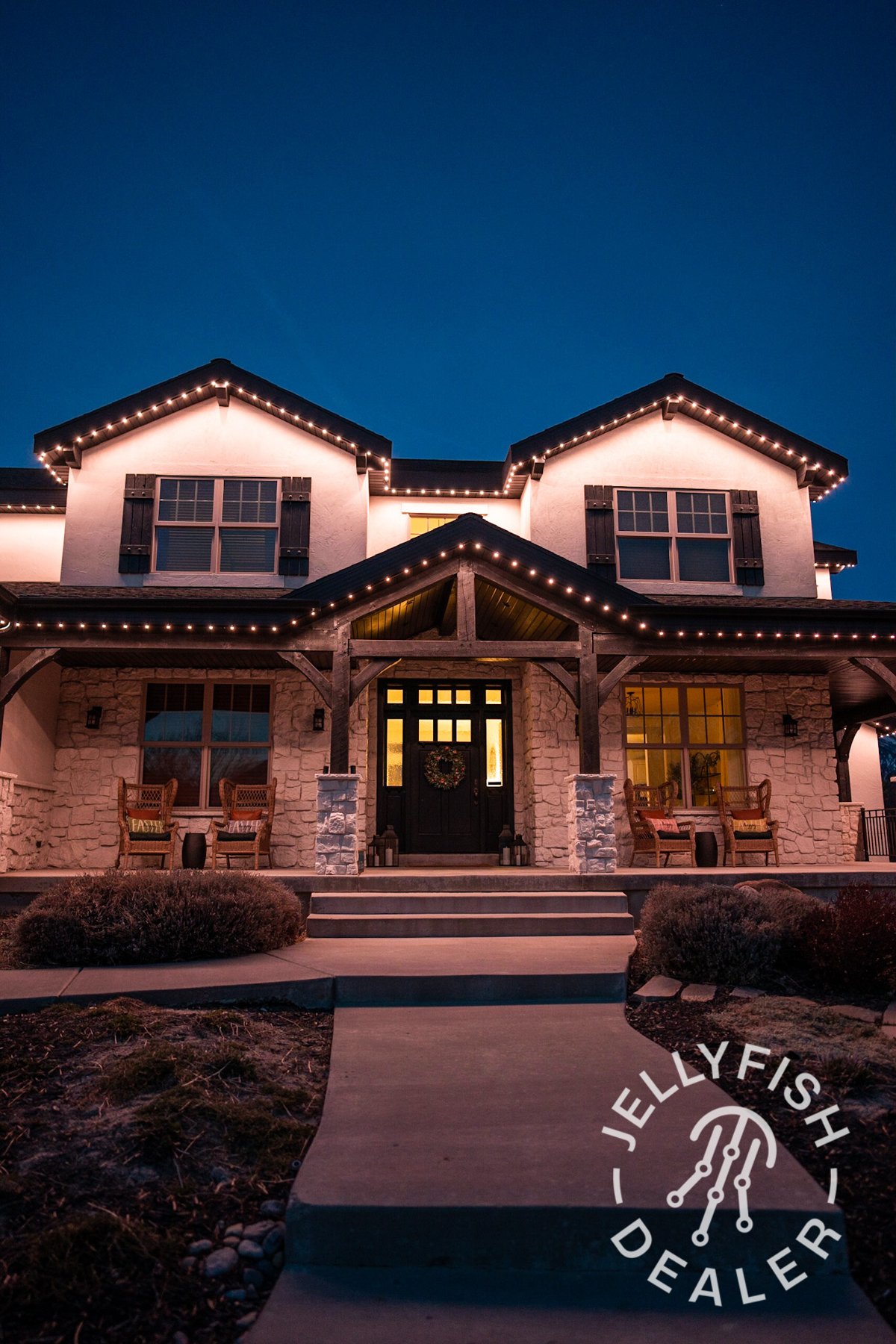 Warm white eave lighting across a home entrance and driveway.