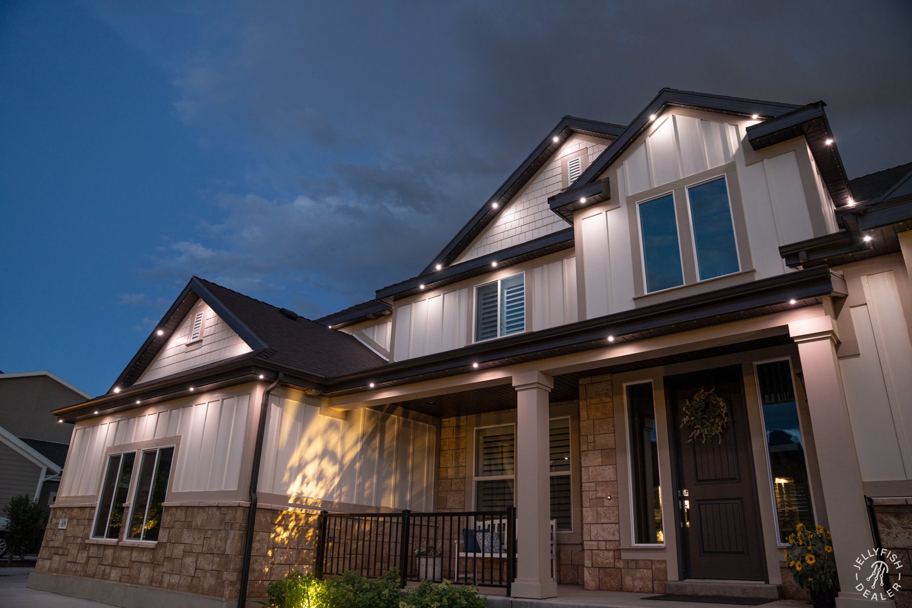 Selective white accent lighting emphasizing gables and stonework.