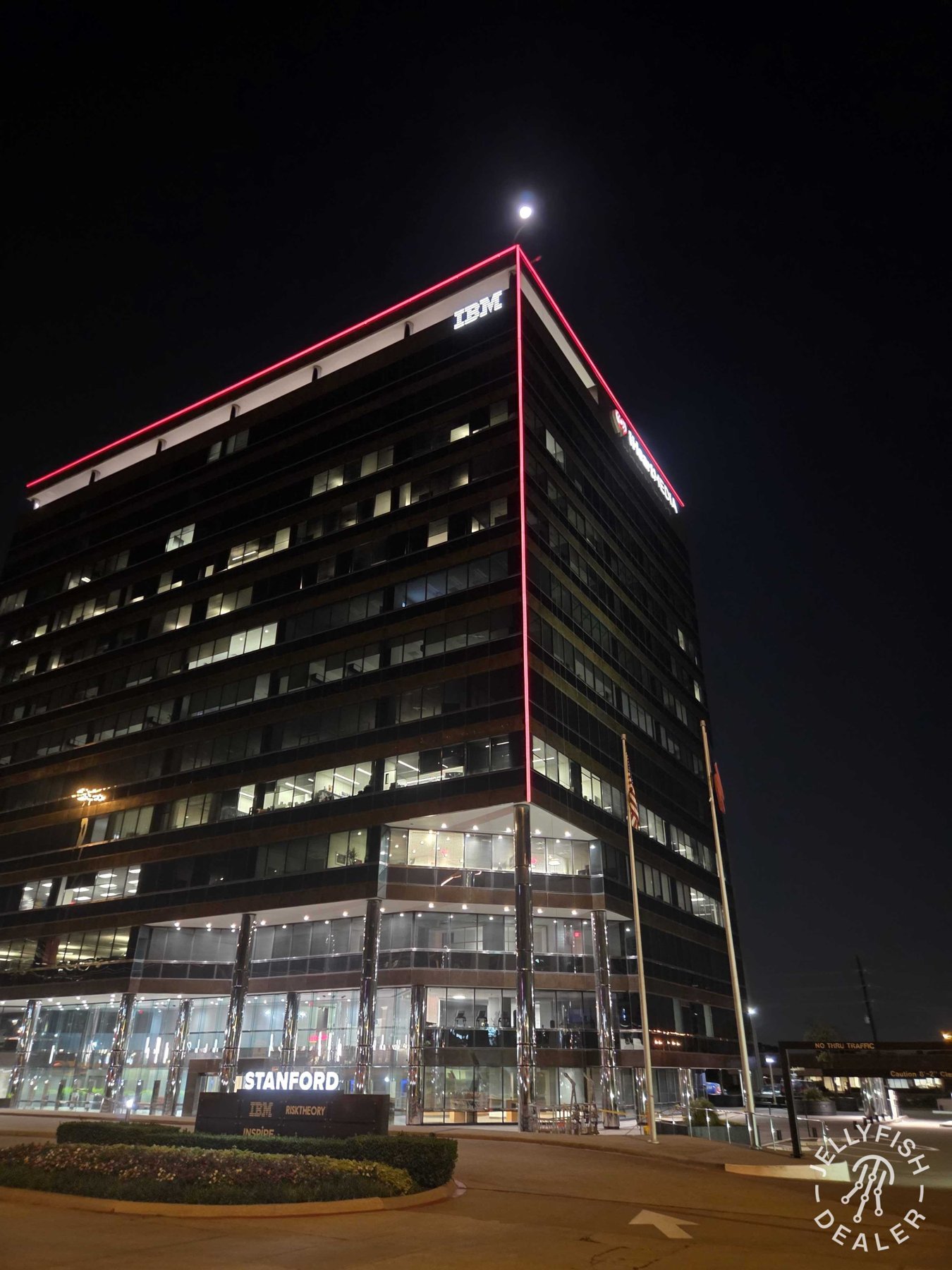 Colored roofline lighting on a multistory office building.