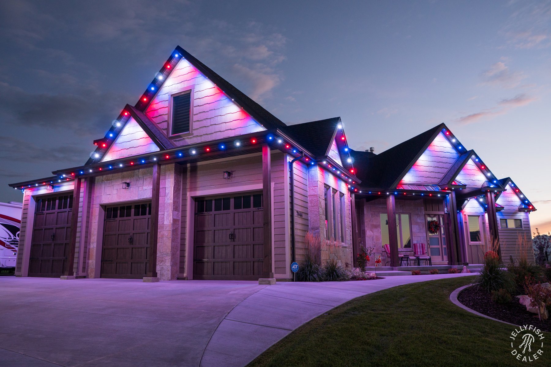 Red, white and blue lighting outlining a home and garage.